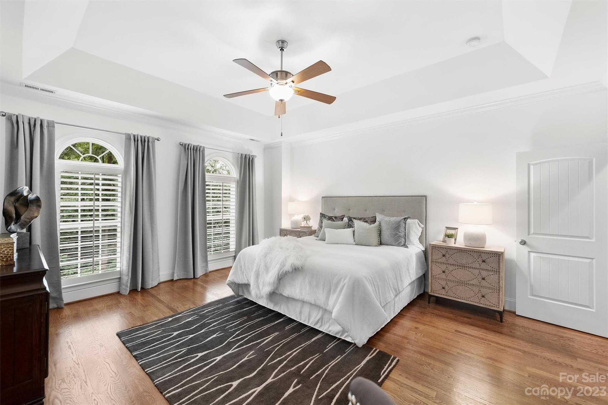 3118 Sharon View Road Charlotte, NC 28210 - Photo 4 of 48 a bedroom with a large bed and a chandelier