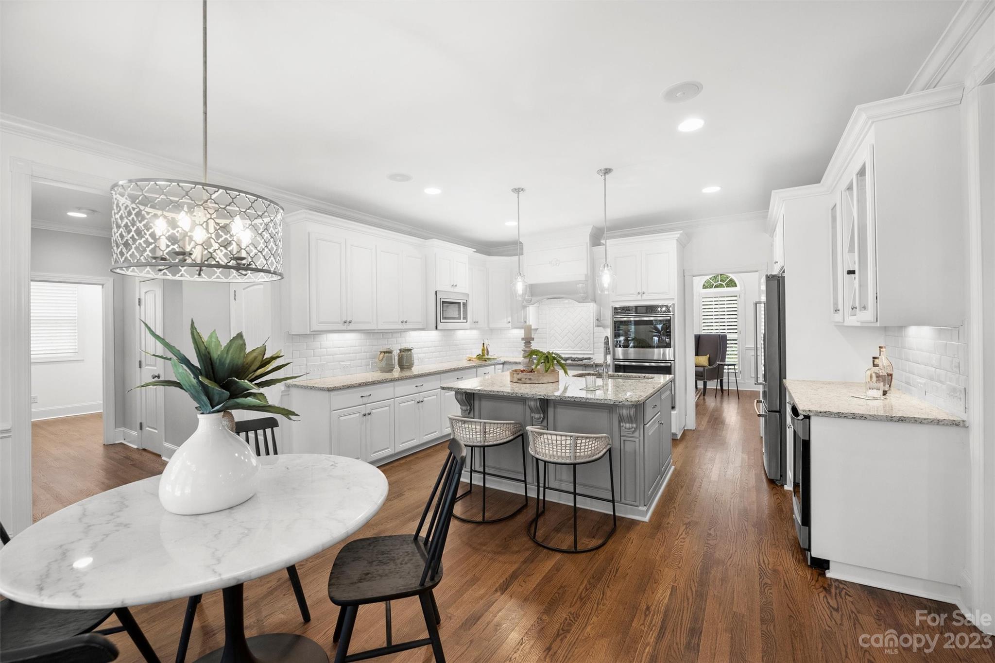 3118 Sharon View Road Charlotte, NC 28210 - Photo 47 of 48 a kitchen with cabinets a sink dishwasher a dining table and chairs with wooden floor