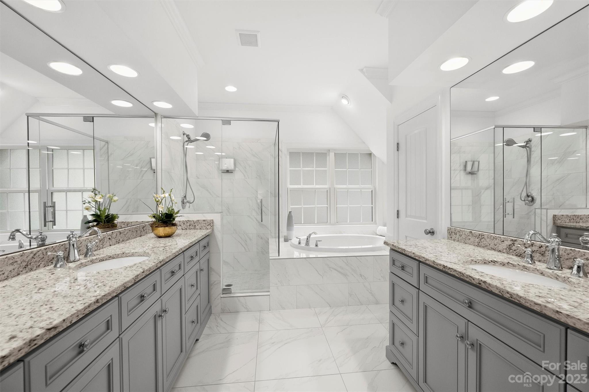 3118 Sharon View Road Charlotte, NC 28210 - Photo 5 of 48 a bathroom with a granite countertop double vanity sink a mirror a bathtub and shower