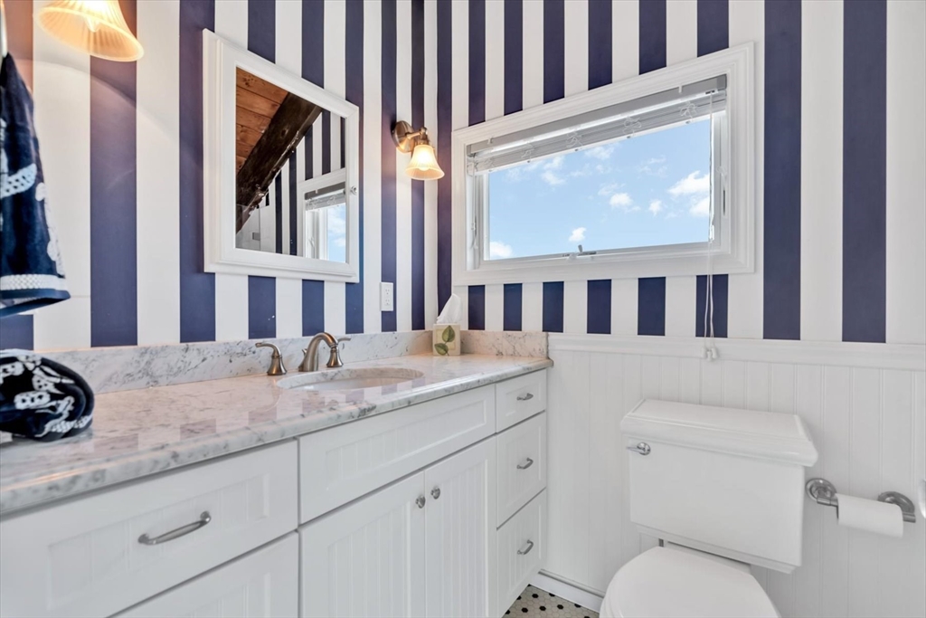 90 Salt Marsh Road East Sandwich, MA 02537 - Photo 31 of 40 a bathroom with a granite countertop toilet sink and mirror