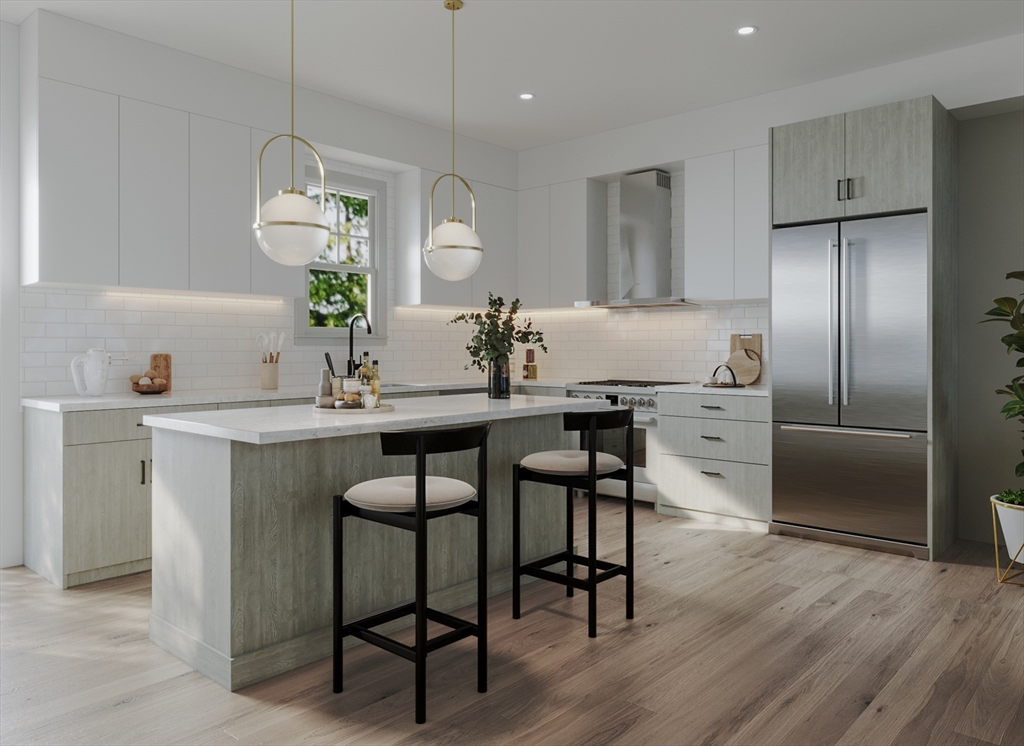 176 School Street, Unit 1 Boston, MA 02130 - Photo 3 of 5 a kitchen with a table chairs refrigerator and microwave