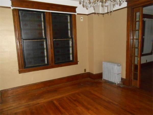 23 Greenbrier Street Springfield, MA 01108 - Photo 4 of 12 a view of empty room with wooden floor and fan