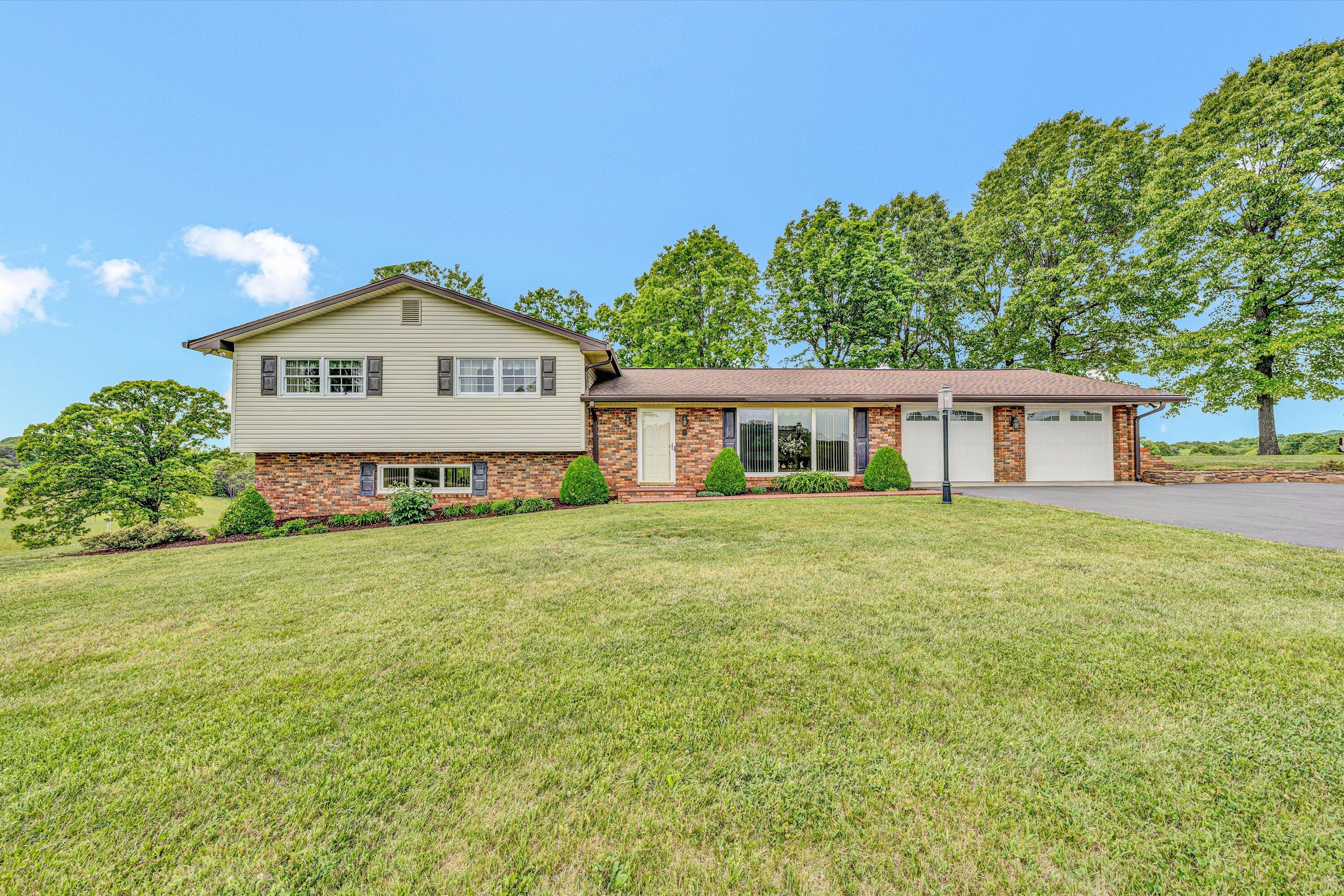 3229 Morgans Mill Road Goodview, VA 24095 - Photo 1 of 60 a front view of a house with a garden