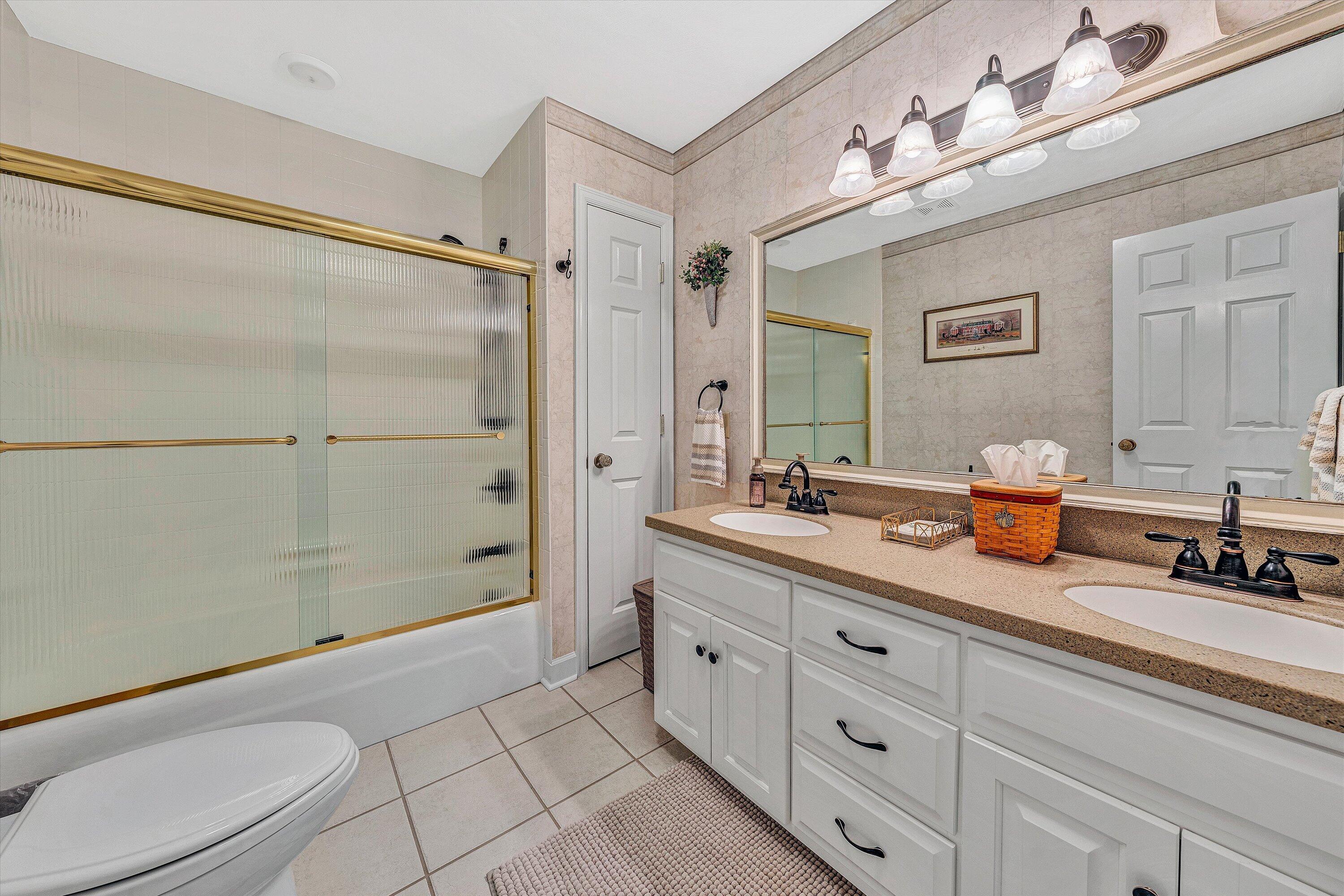 3229 Morgans Mill Road Goodview, VA 24095 - Photo 13 of 60 a spacious bathroom with double vanity a toilet a a mirror a shower a vanity and a bathtub