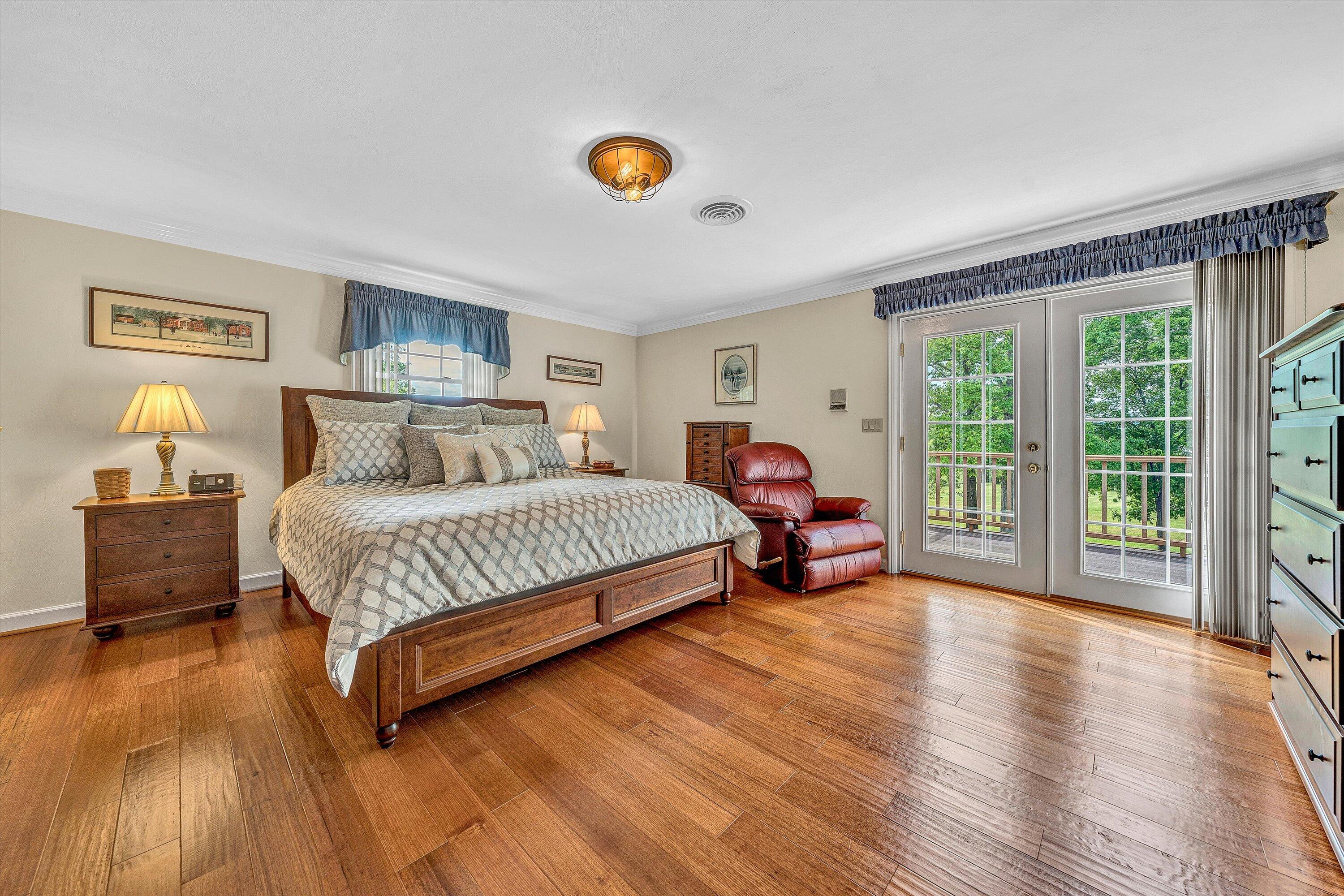 3229 Morgans Mill Road Goodview, VA 24095 - Photo 14 of 60 a bedroom with a bed and a view of balcony