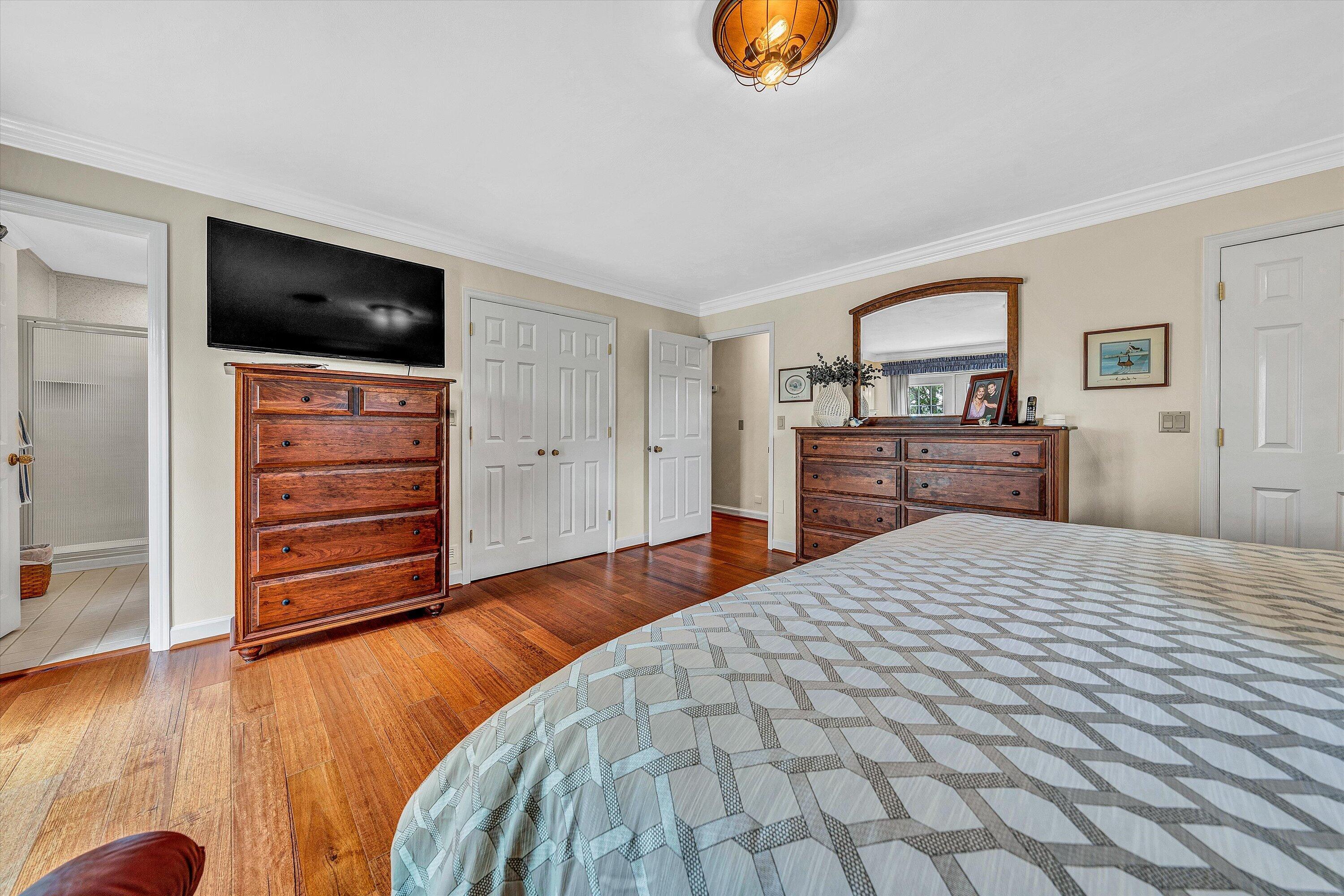 3229 Morgans Mill Road Goodview, VA 24095 - Photo 15 of 60 a bedroom with a bed and wooden floor