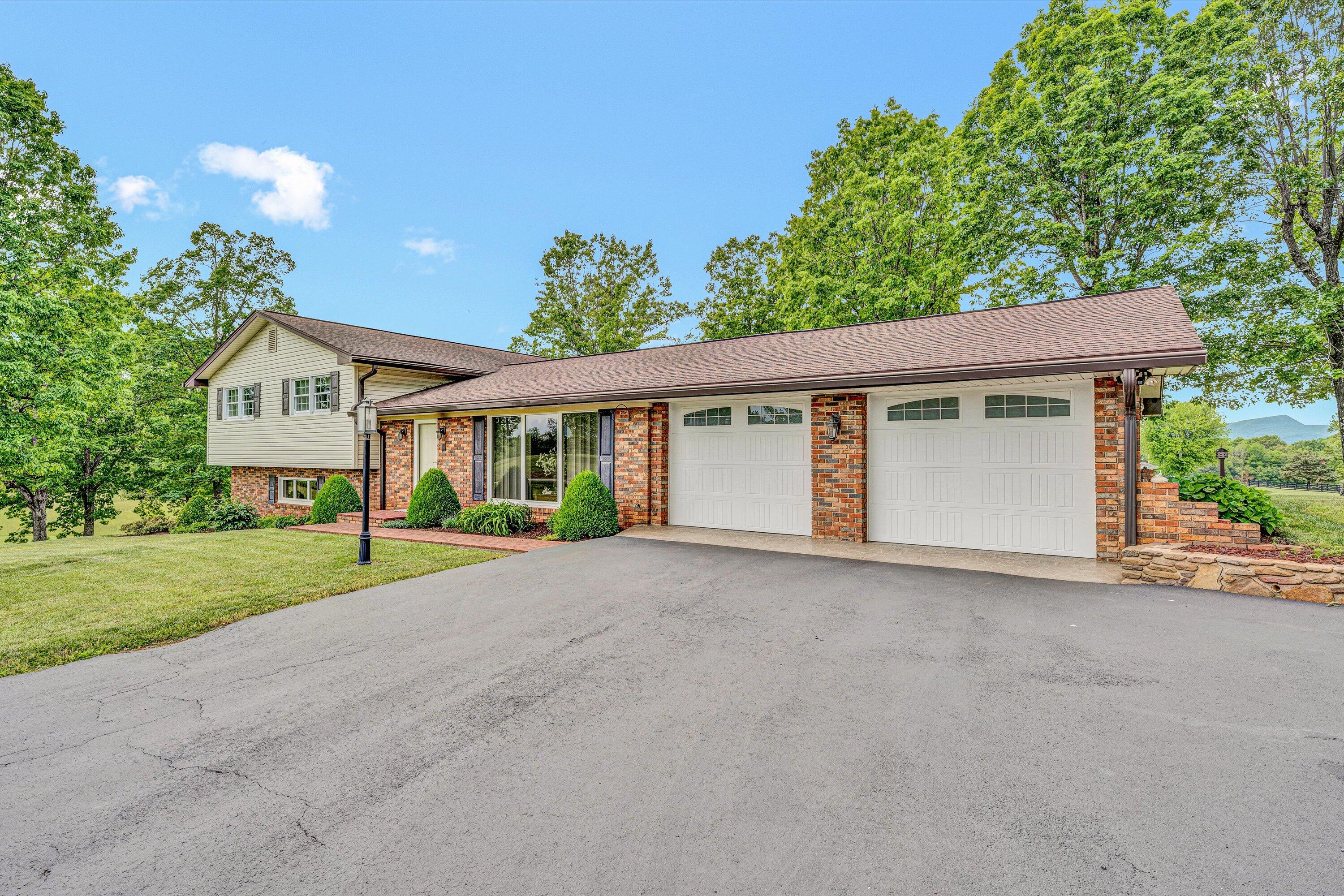 3229 Morgans Mill Road Goodview, VA 24095 - Photo 2 of 60 front view of a house with a yard and an trees
