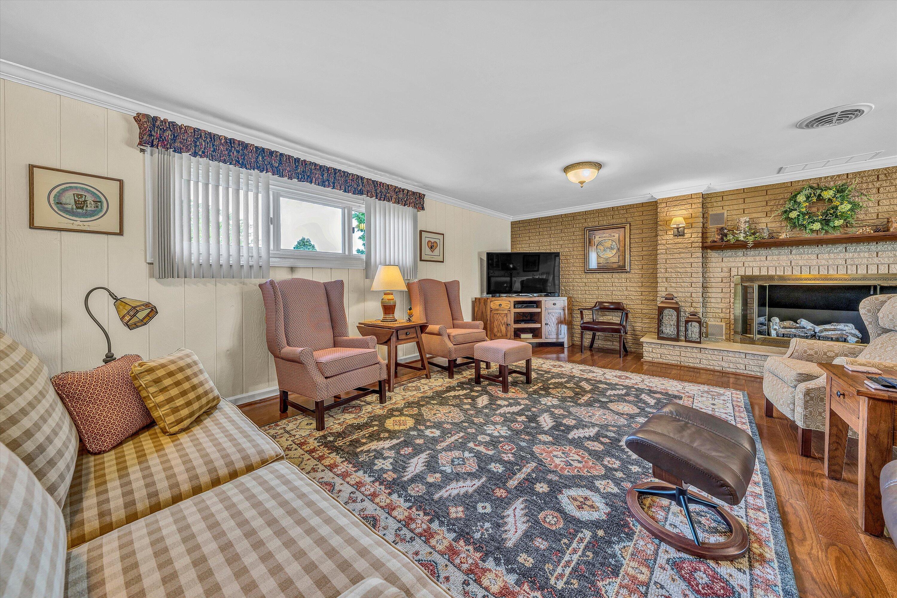 3229 Morgans Mill Road Goodview, VA 24095 - Photo 23 of 60 a living room with furniture large window and a fireplace