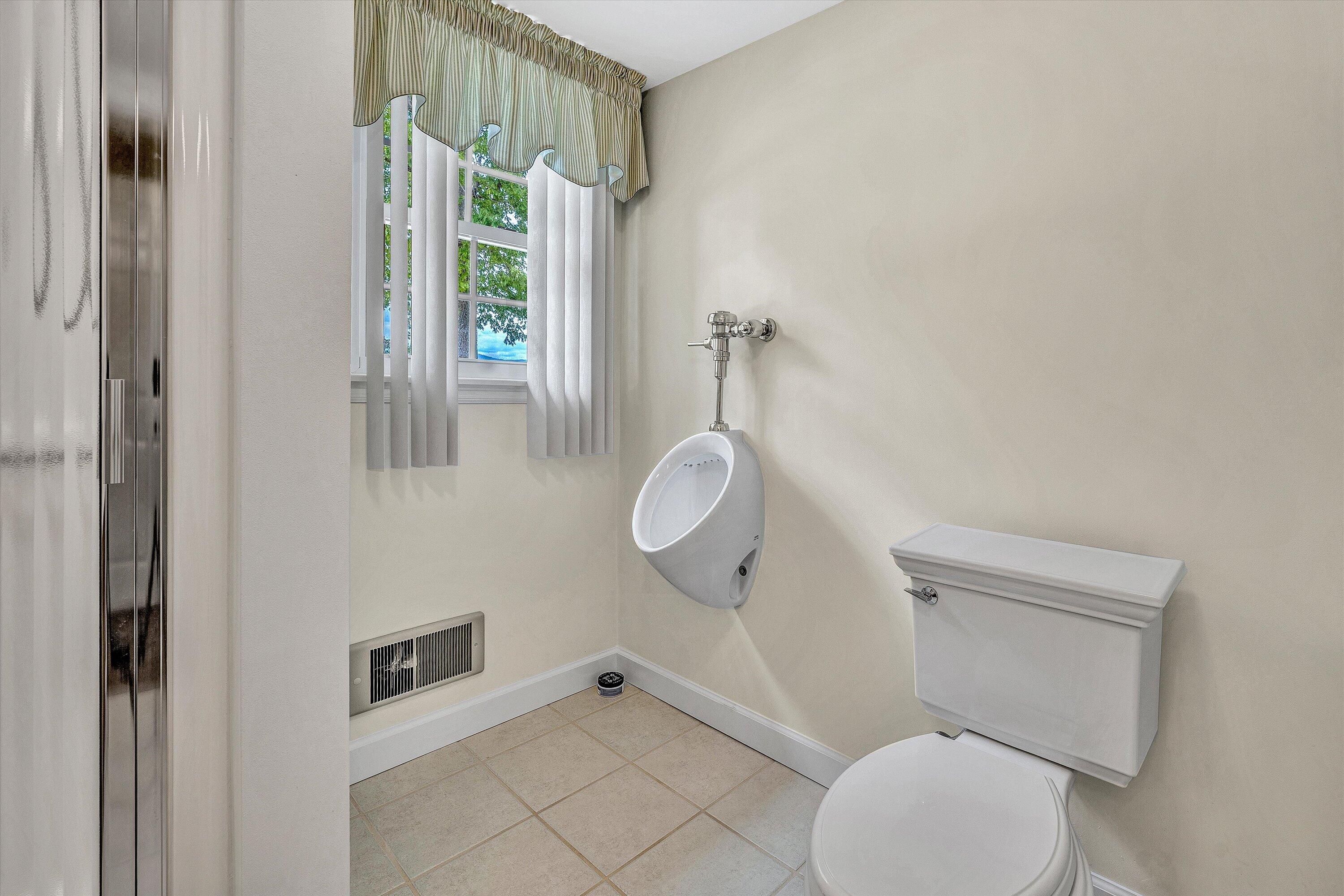 3229 Morgans Mill Road Goodview, VA 24095 - Photo 29 of 60 a bathroom with a toilet and a shower