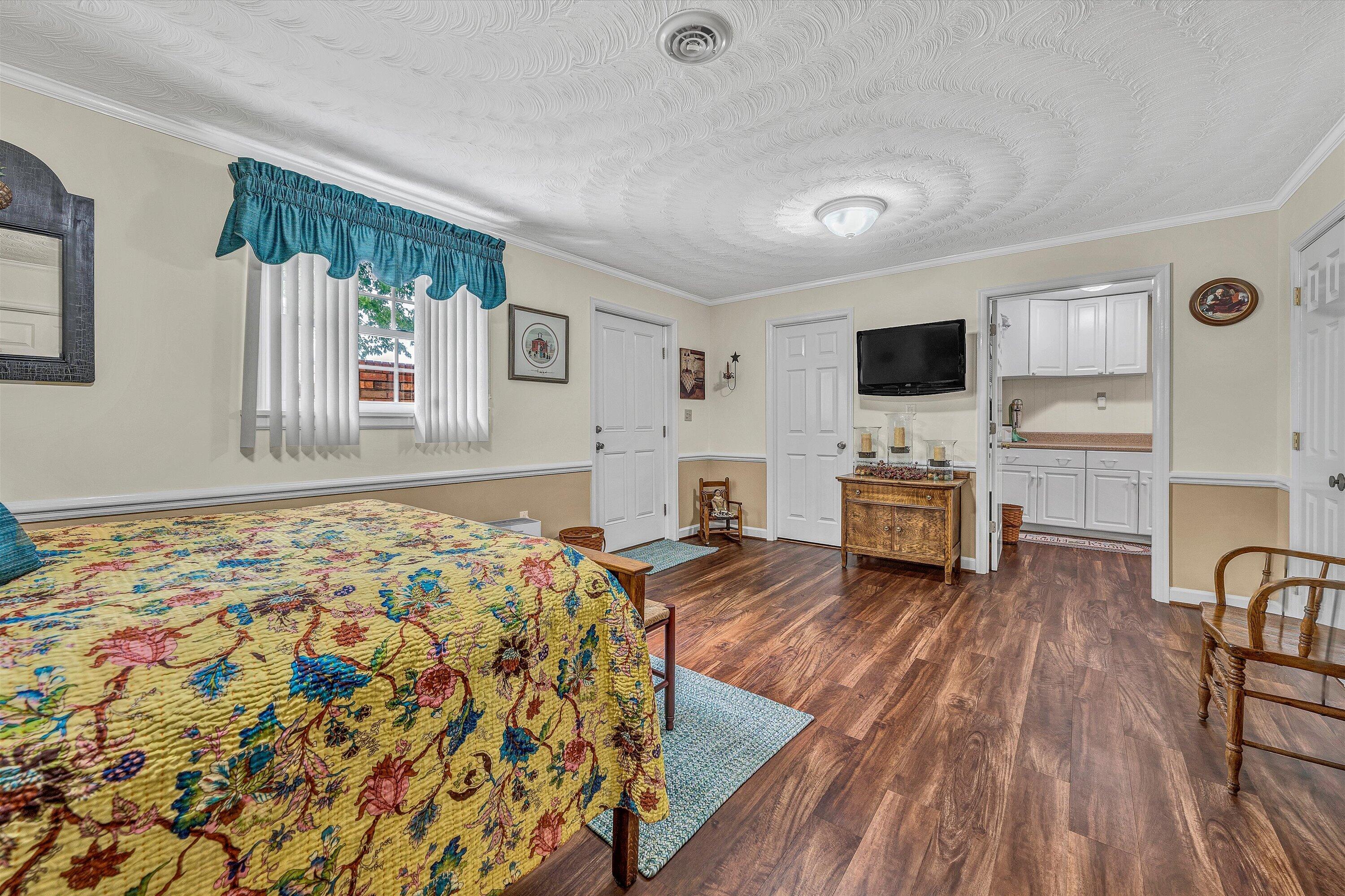 3229 Morgans Mill Road Goodview, VA 24095 - Photo 30 of 60 a spacious bedroom with a bed and flat screen tv
