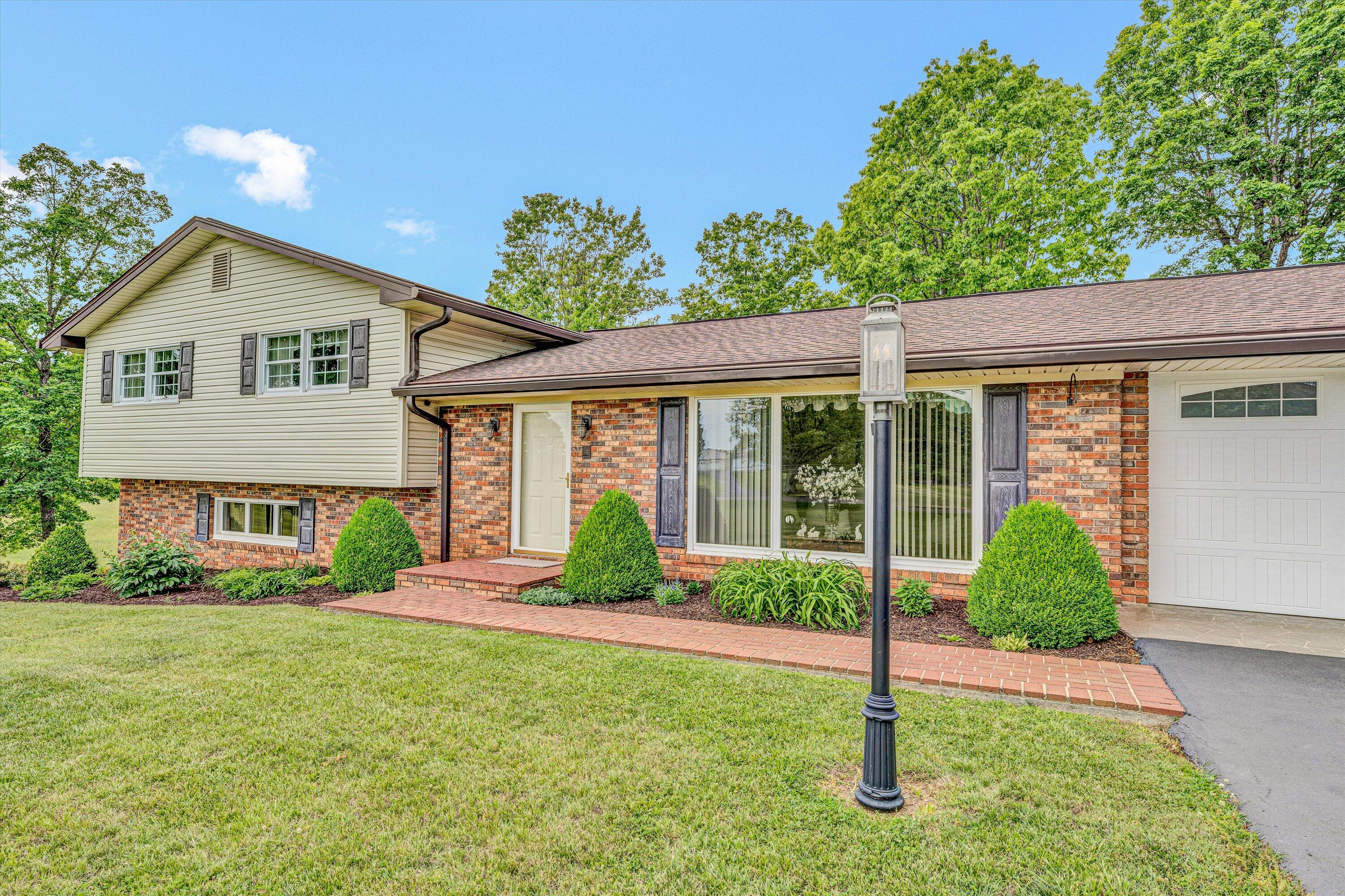 3229 Morgans Mill Road Goodview, VA 24095 - Photo 3 of 60 a front view of a house with a yard and porch
