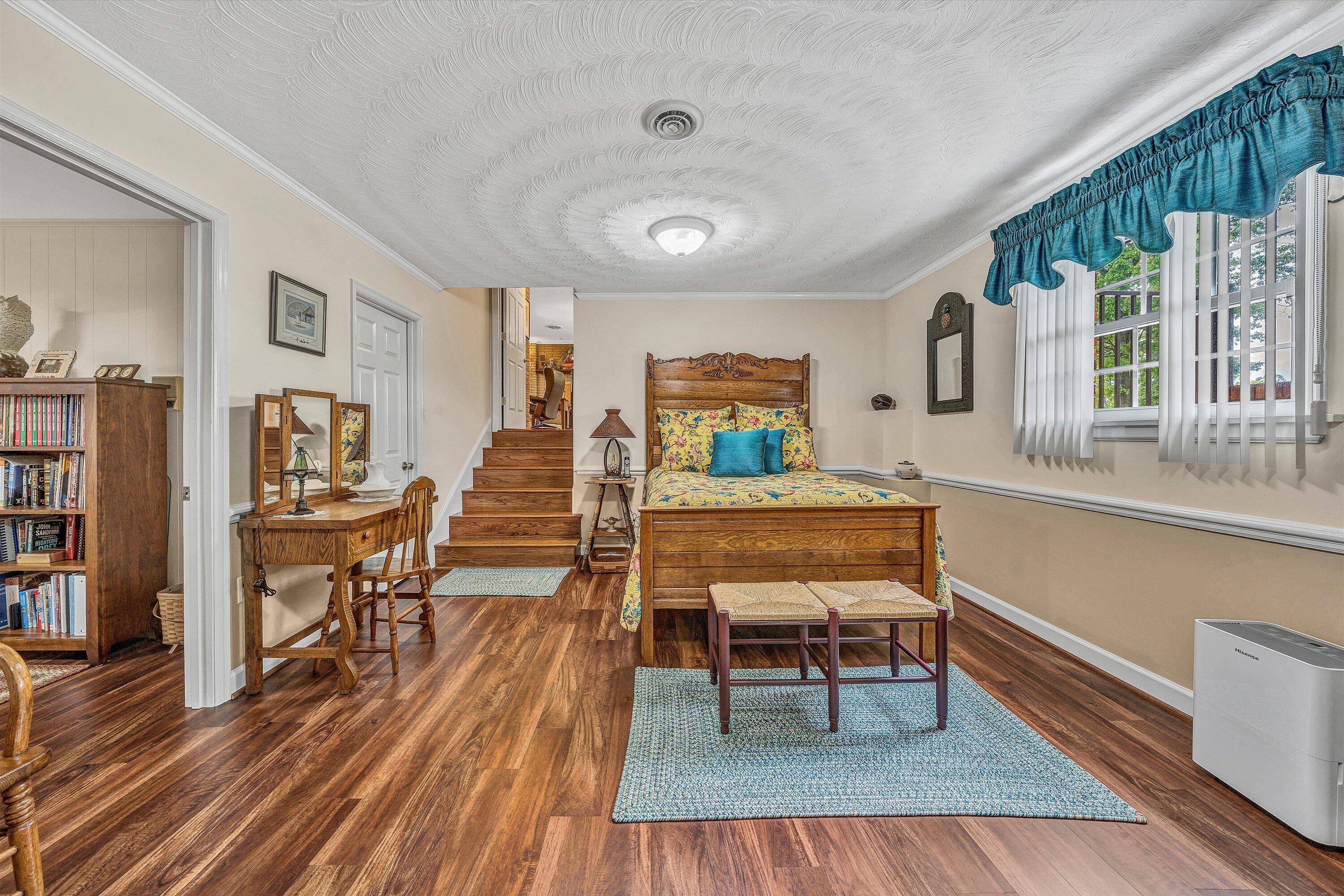 3229 Morgans Mill Road Goodview, VA 24095 - Photo 31 of 60 a dining room with wooden floor a glass table and chairs