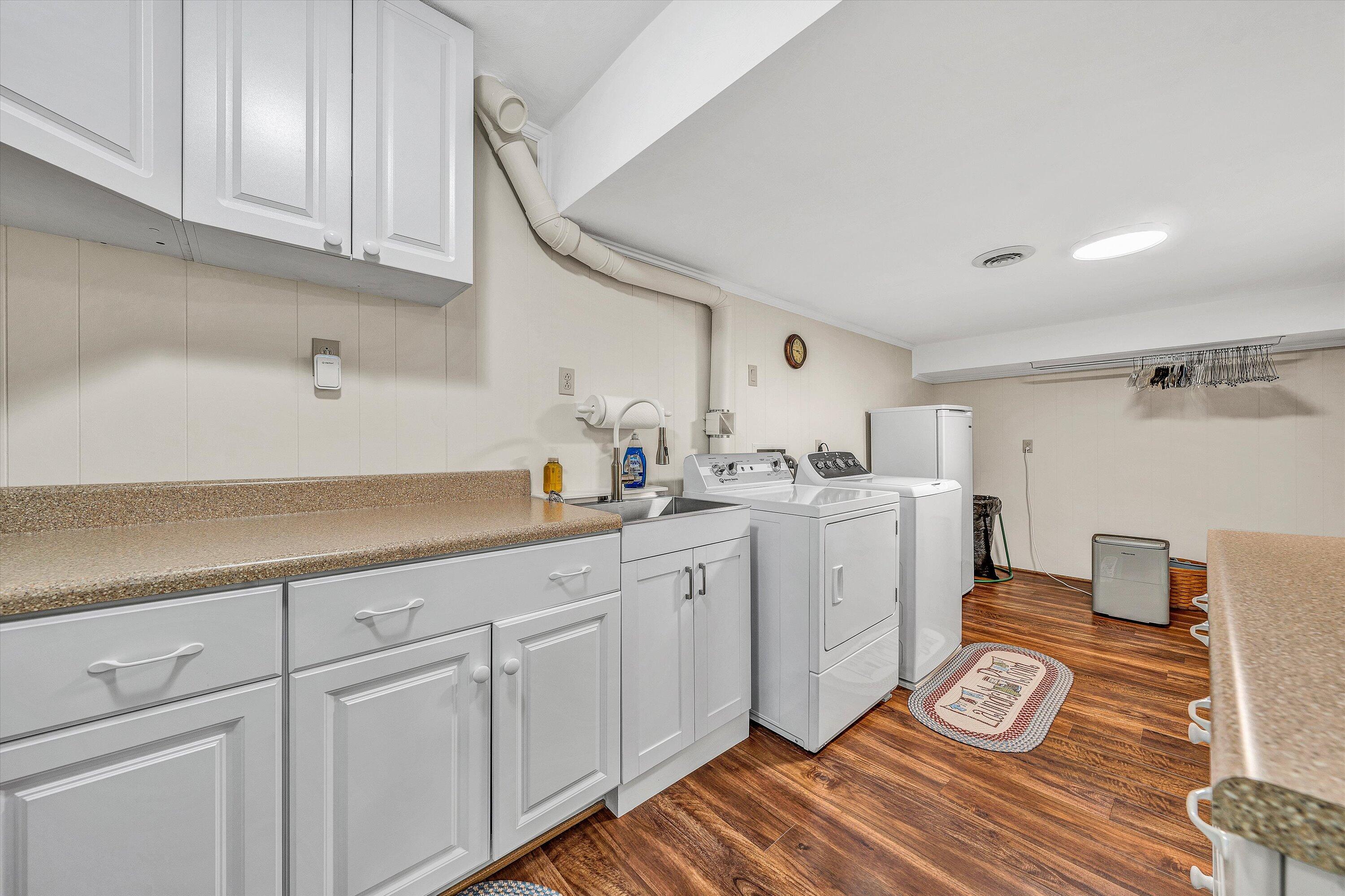 3229 Morgans Mill Road Goodview, VA 24095 - Photo 32 of 60 a kitchen with sink cabinets and wooden floor