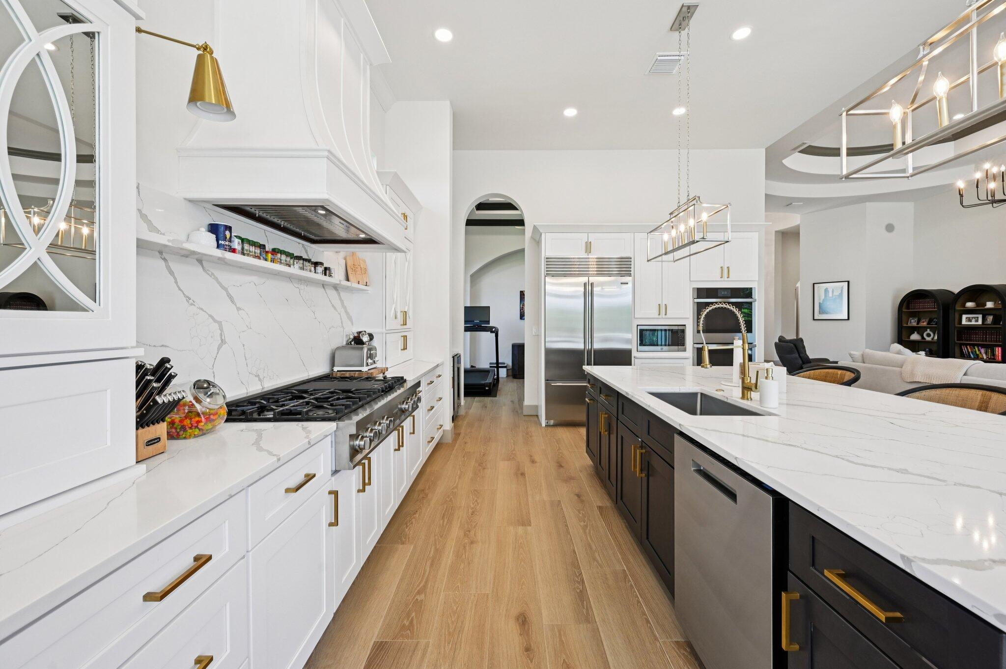 9936 Southeast Sandpine Lane Hobe Sound, FL 33455 - Photo 16 of 71 a kitchen with stainless steel appliances a sink stove and cabinets
