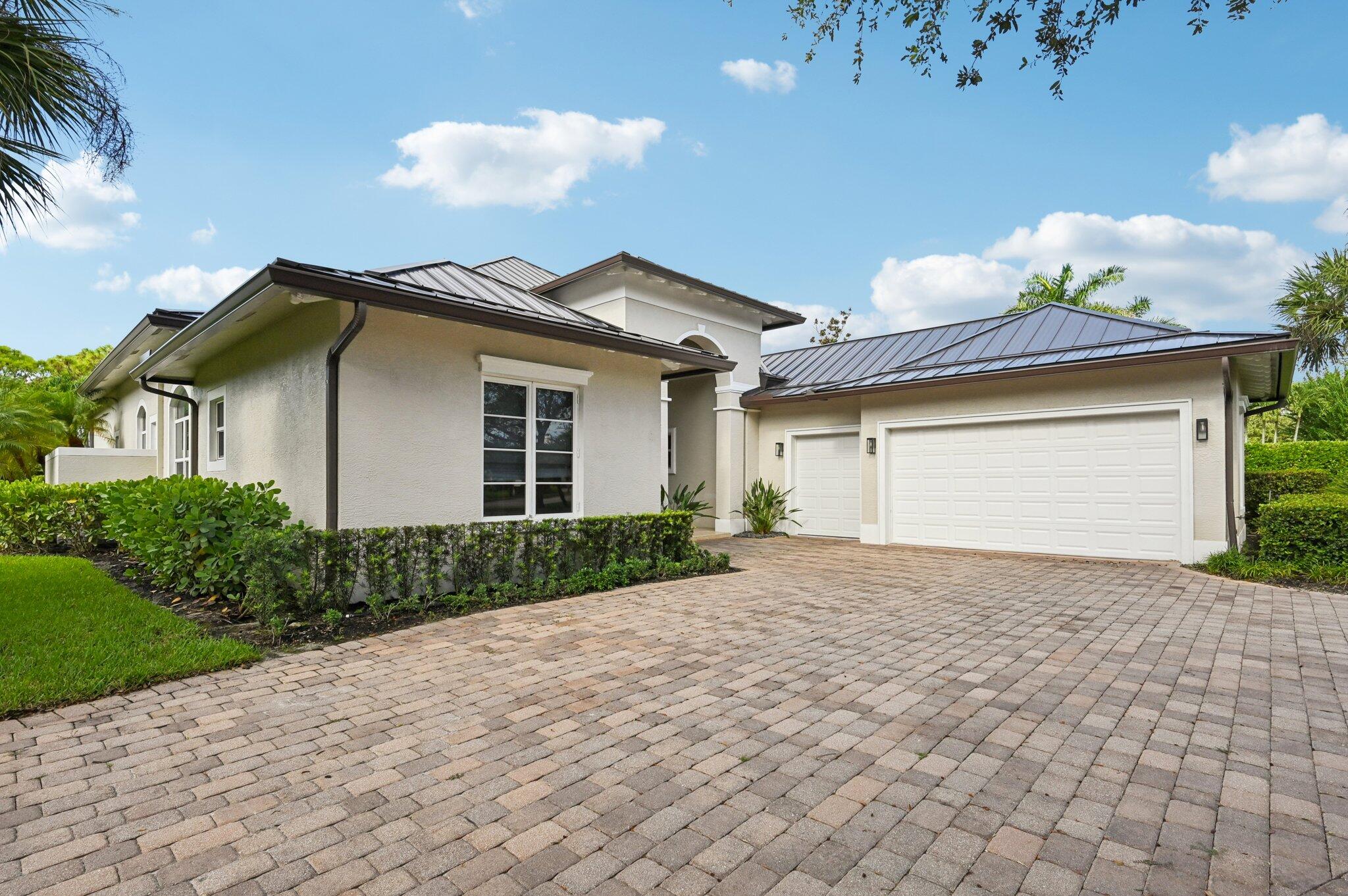 9936 Southeast Sandpine Lane Hobe Sound, FL 33455 - Photo 2 of 71 a view of a house with a yard and potted plants