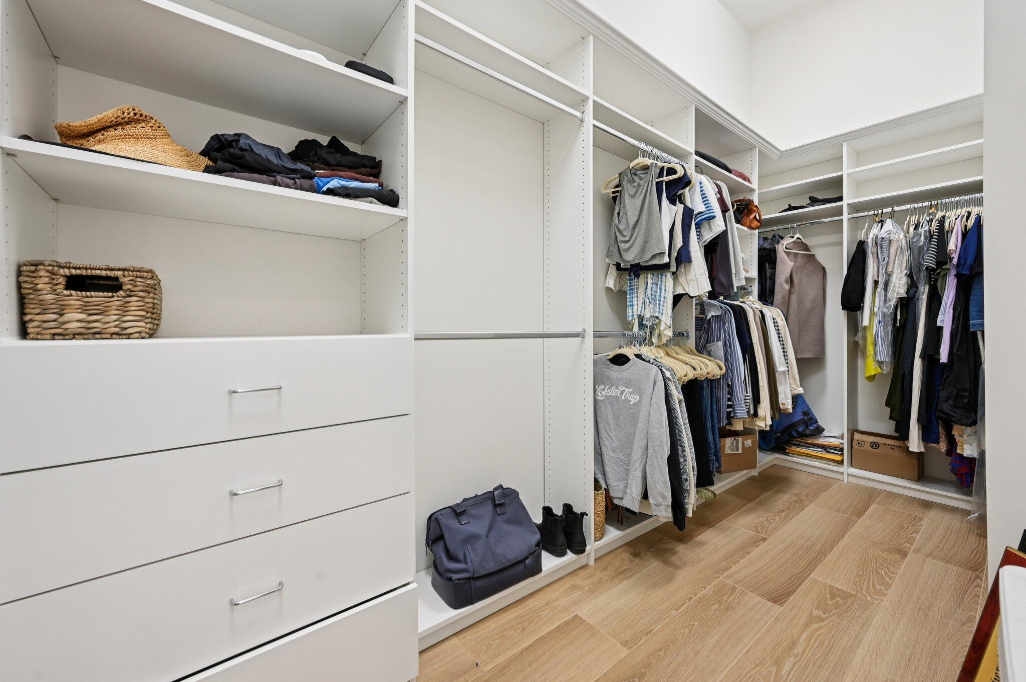 9936 Southeast Sandpine Lane Hobe Sound, FL 33455 - Photo 26 of 71 a view of walk in closet with clothes and shoes