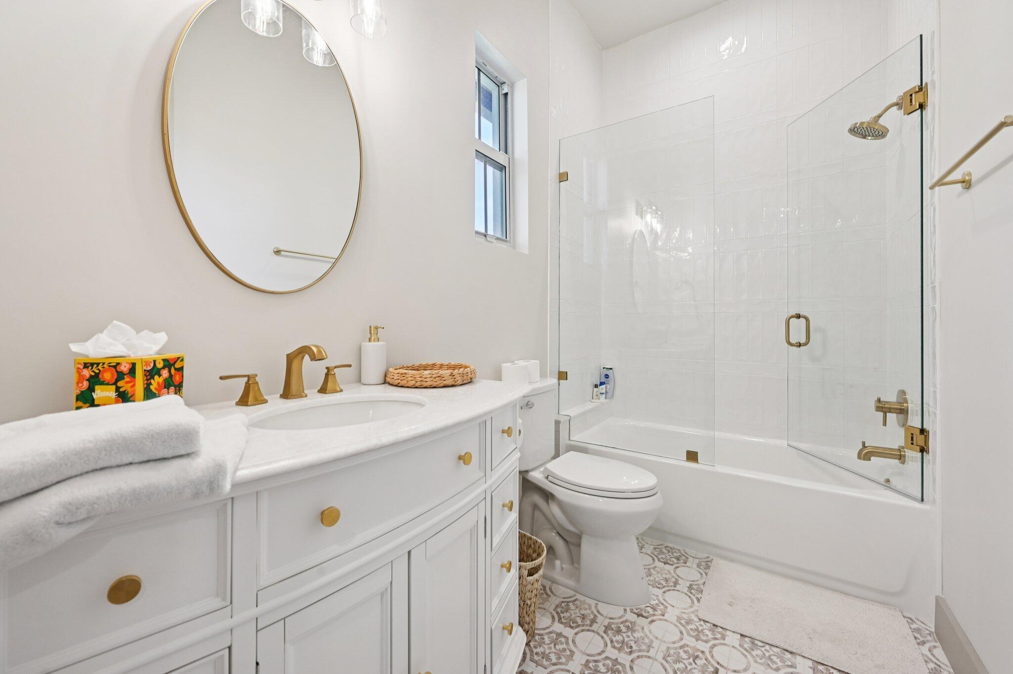 9936 Southeast Sandpine Lane Hobe Sound, FL 33455 - Photo 28 of 71 a bathroom with a sink a toilet and a mirror