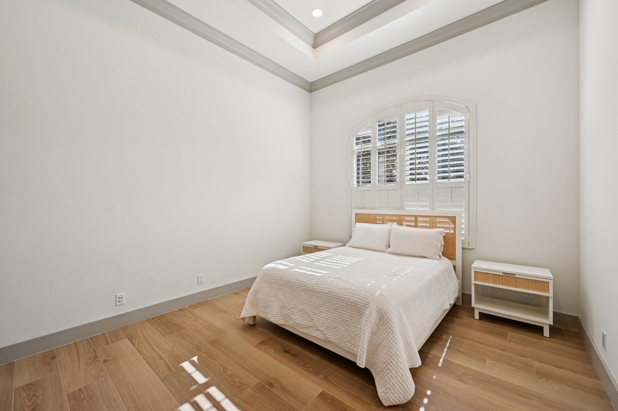 9936 Southeast Sandpine Lane Hobe Sound, FL 33455 - Photo 32 of 71 a bedroom with a bed and a night stand