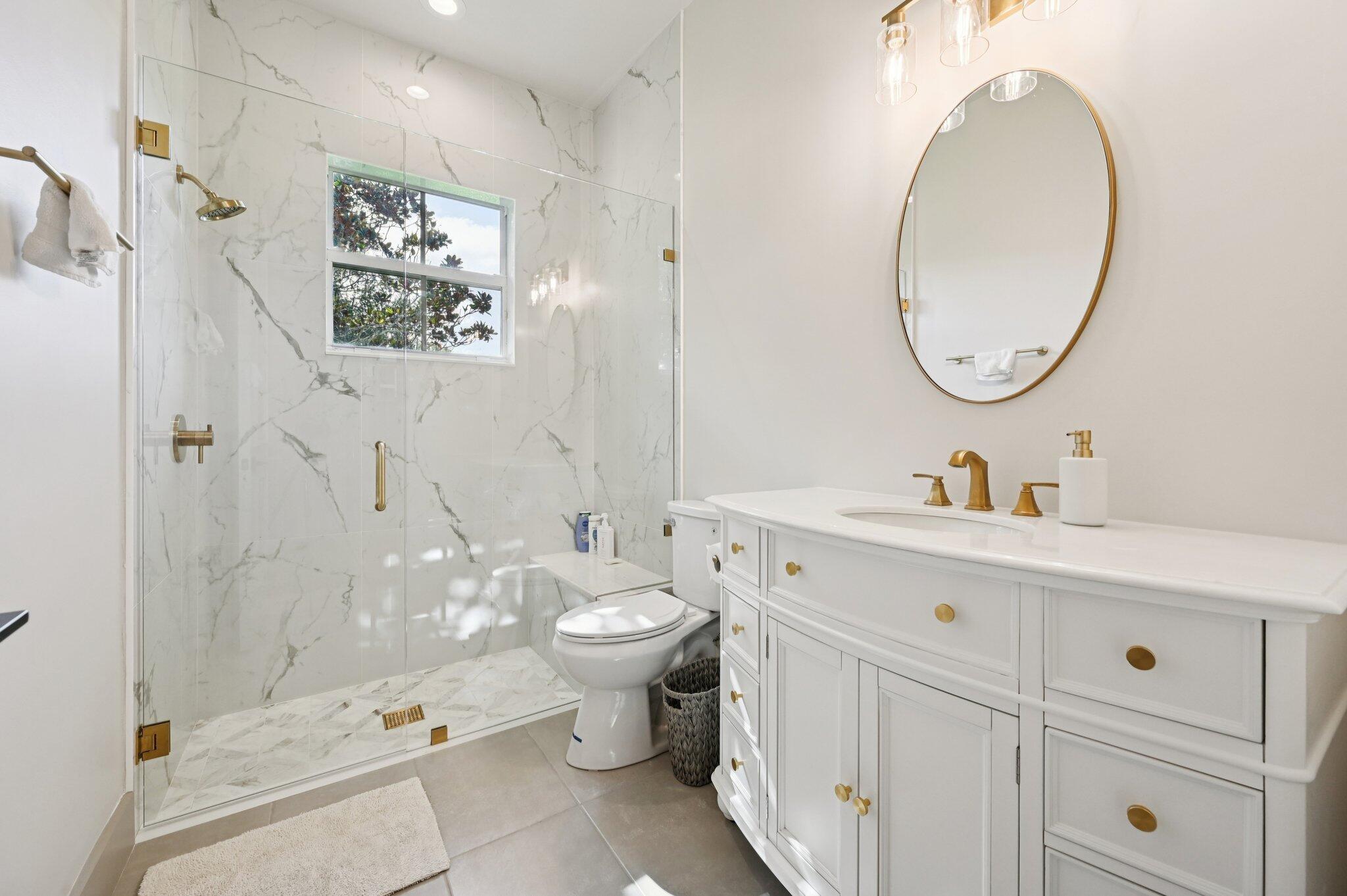 9936 Southeast Sandpine Lane Hobe Sound, FL 33455 - Photo 33 of 71 a bathroom with a double vanity sink mirror and toilet