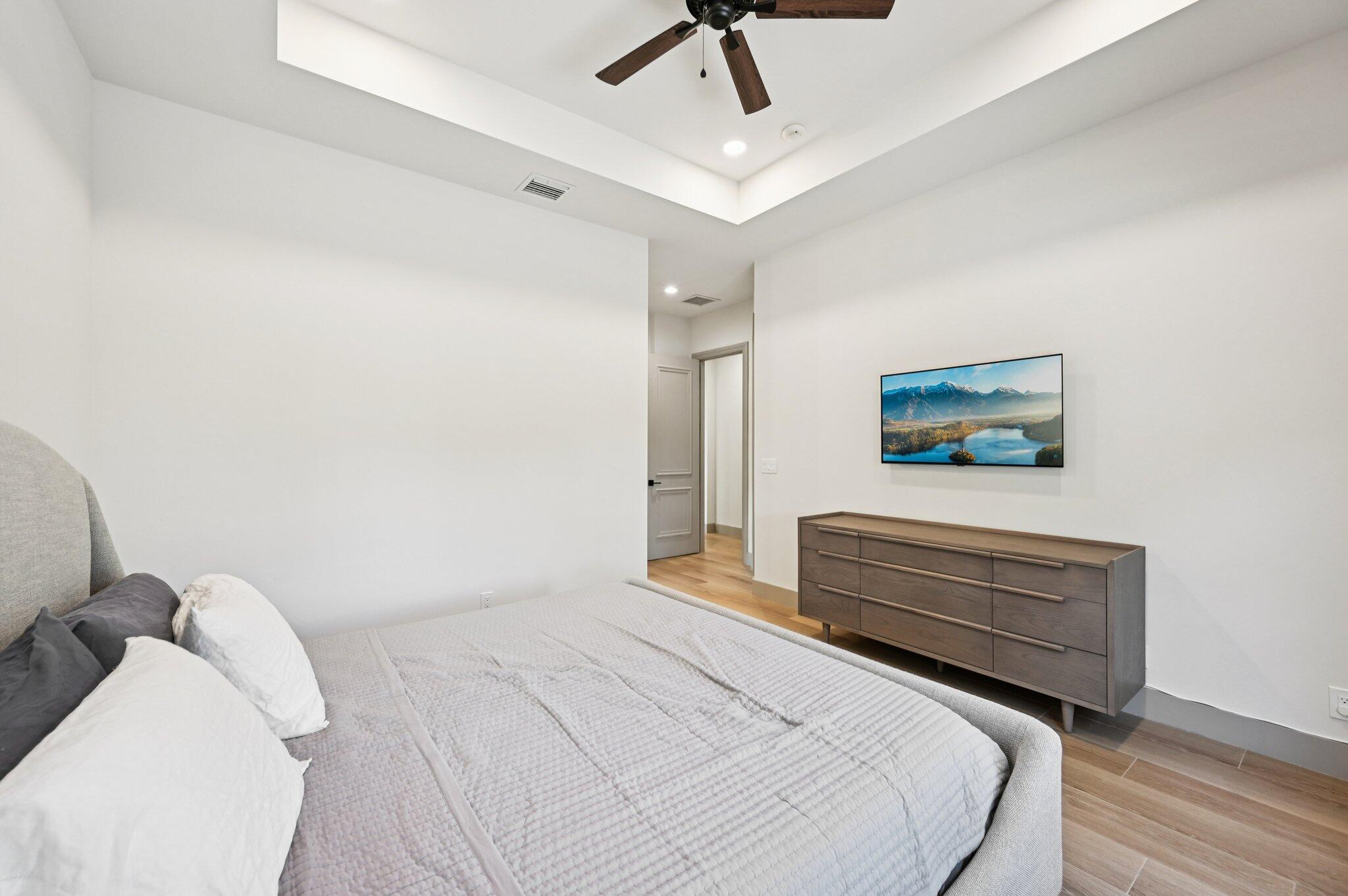 9936 Southeast Sandpine Lane Hobe Sound, FL 33455 - Photo 34 of 71 a bedroom with a bed and a painting on the wall