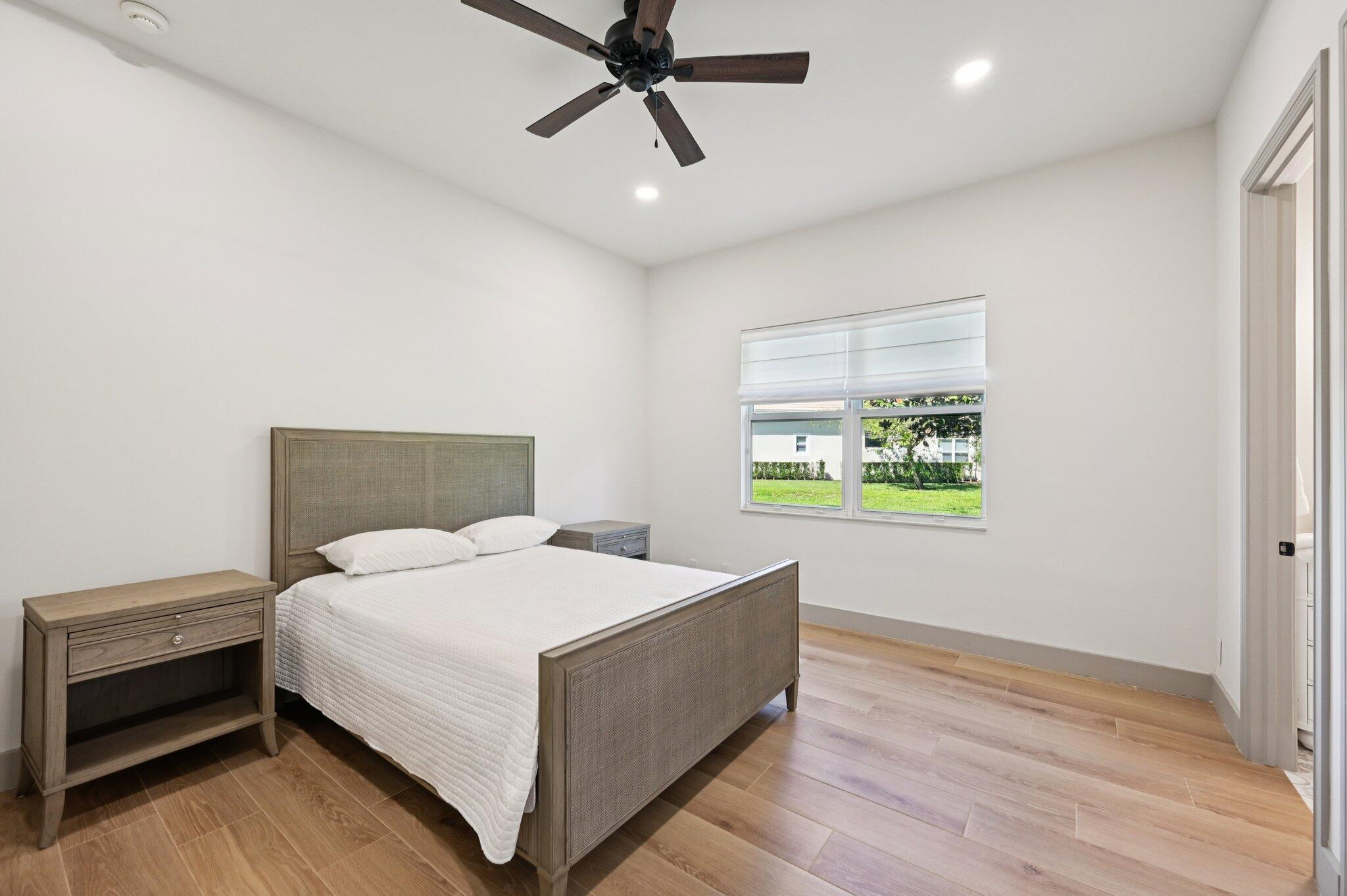 9936 Southeast Sandpine Lane Hobe Sound, FL 33455 - Photo 36 of 71 a bedroom with a bed and window