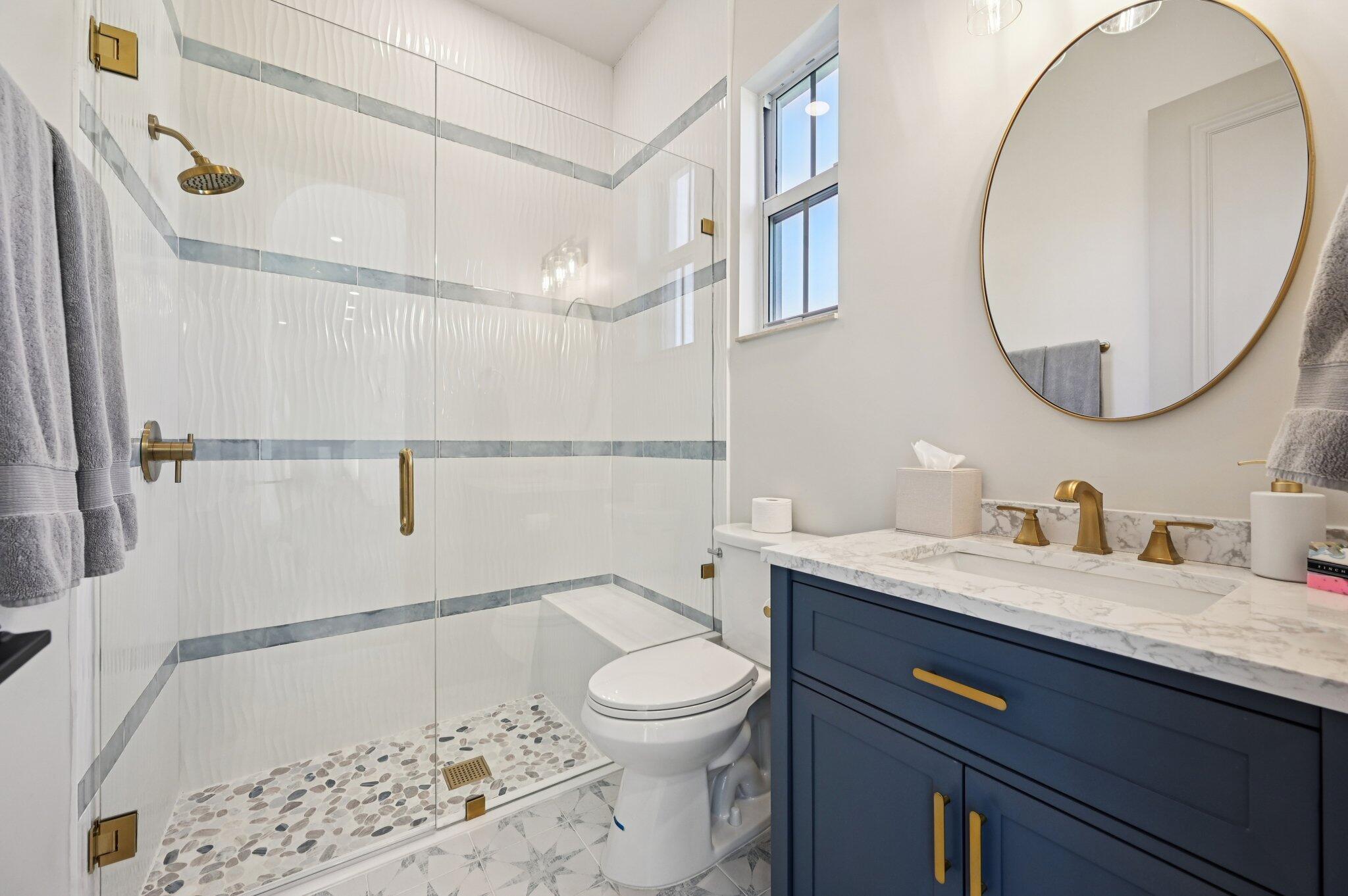 9936 Southeast Sandpine Lane Hobe Sound, FL 33455 - Photo 37 of 71 a bathroom with a granite countertop sink a toilet and a mirror