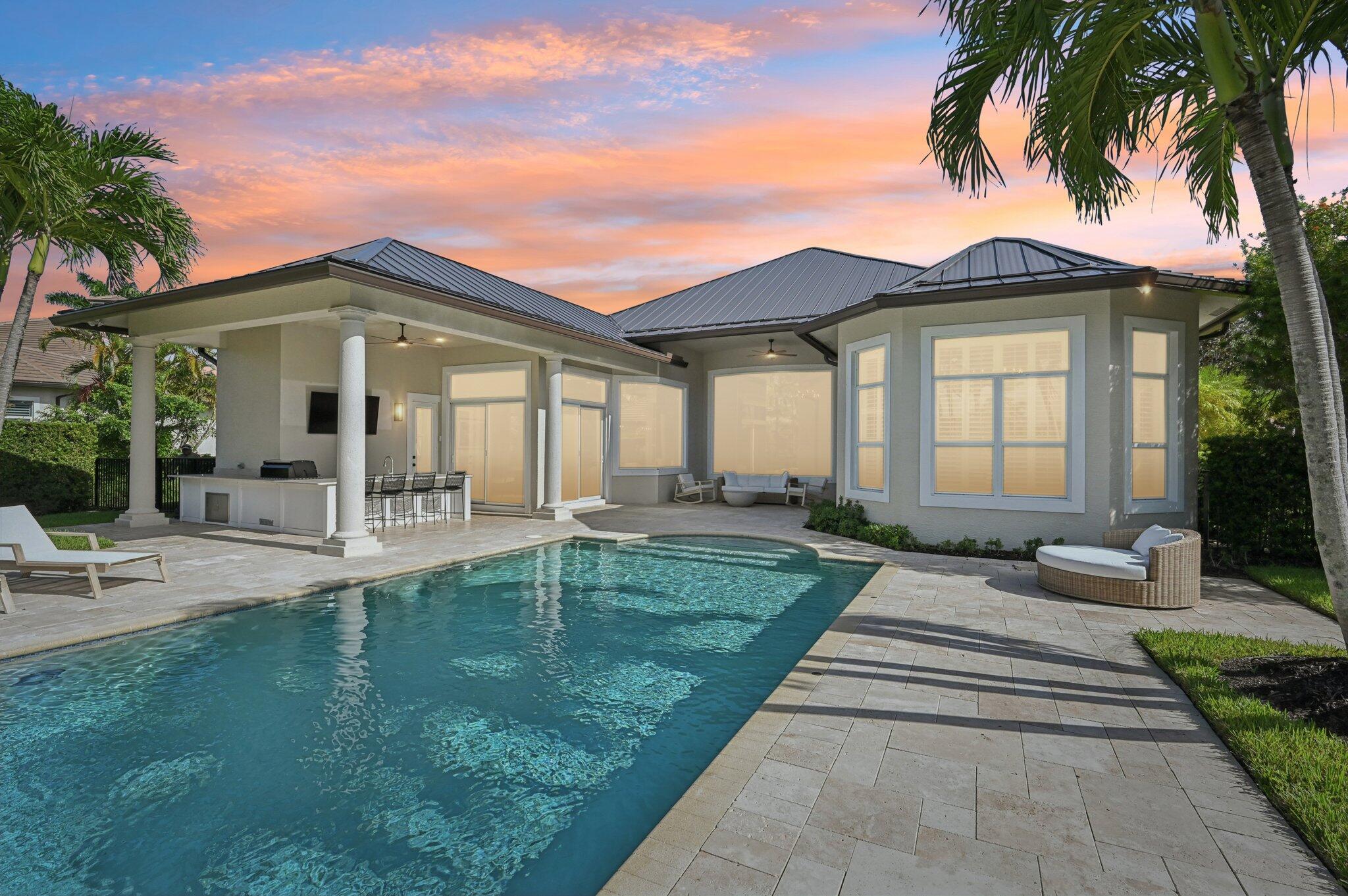 9936 Southeast Sandpine Lane Hobe Sound, FL 33455 - Photo 4 of 71 a front view of a house with garden