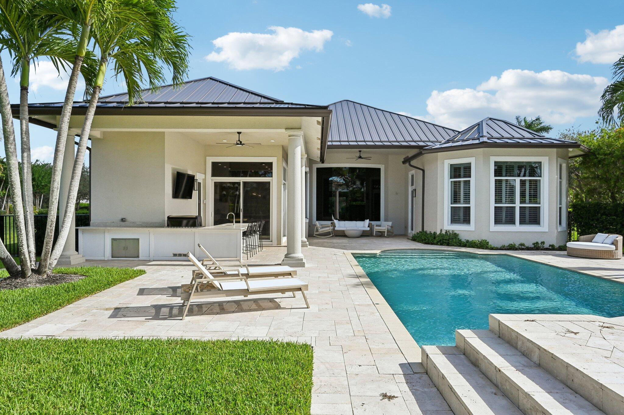 9936 Southeast Sandpine Lane Hobe Sound, FL 33455 - Photo 42 of 71 a view of a house with backyard porch and sitting area