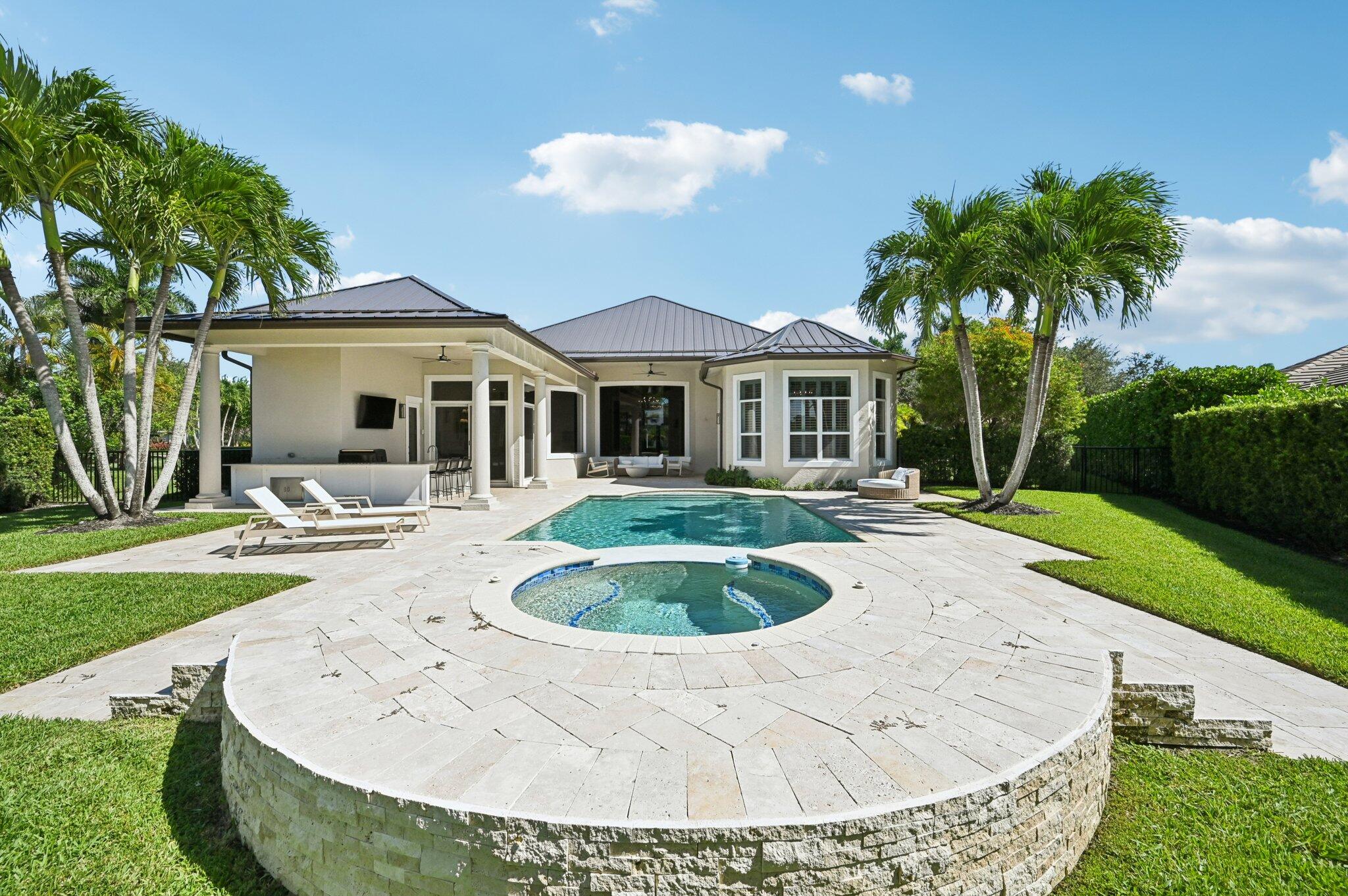 9936 Southeast Sandpine Lane Hobe Sound, FL 33455 - Photo 44 of 71 a view of a house with swimming pool and a yard