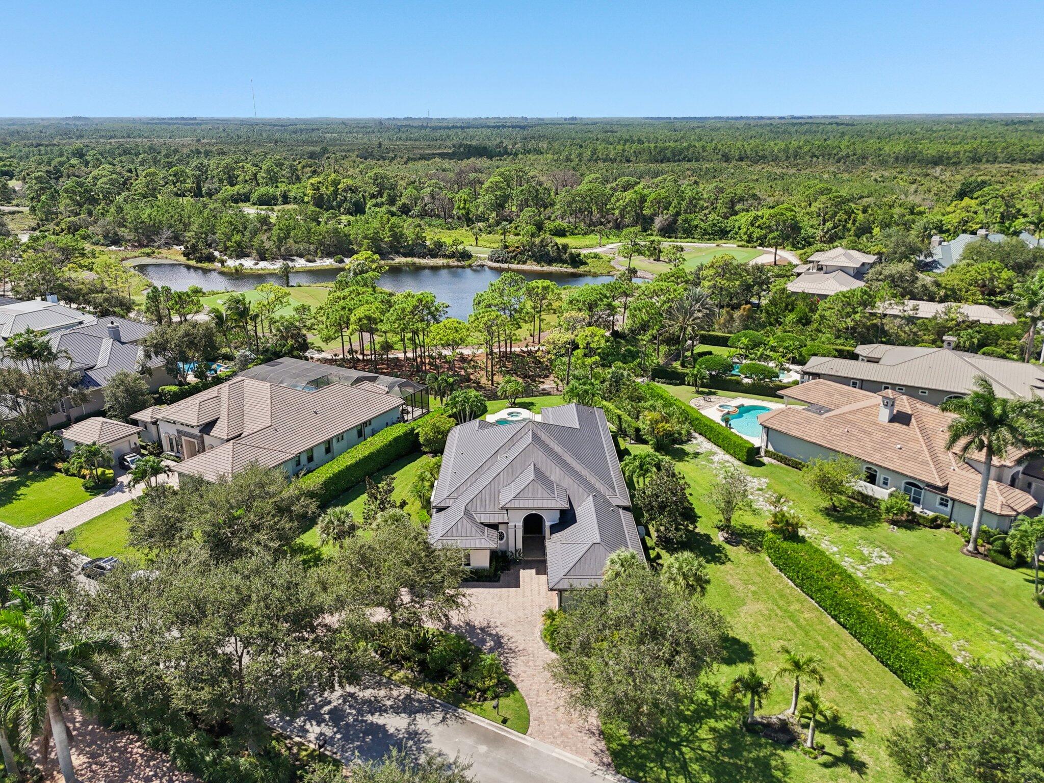 9936 Southeast Sandpine Lane Hobe Sound, FL 33455 - Photo 53 of 71 an aerial view of residential houses with outdoor space and river