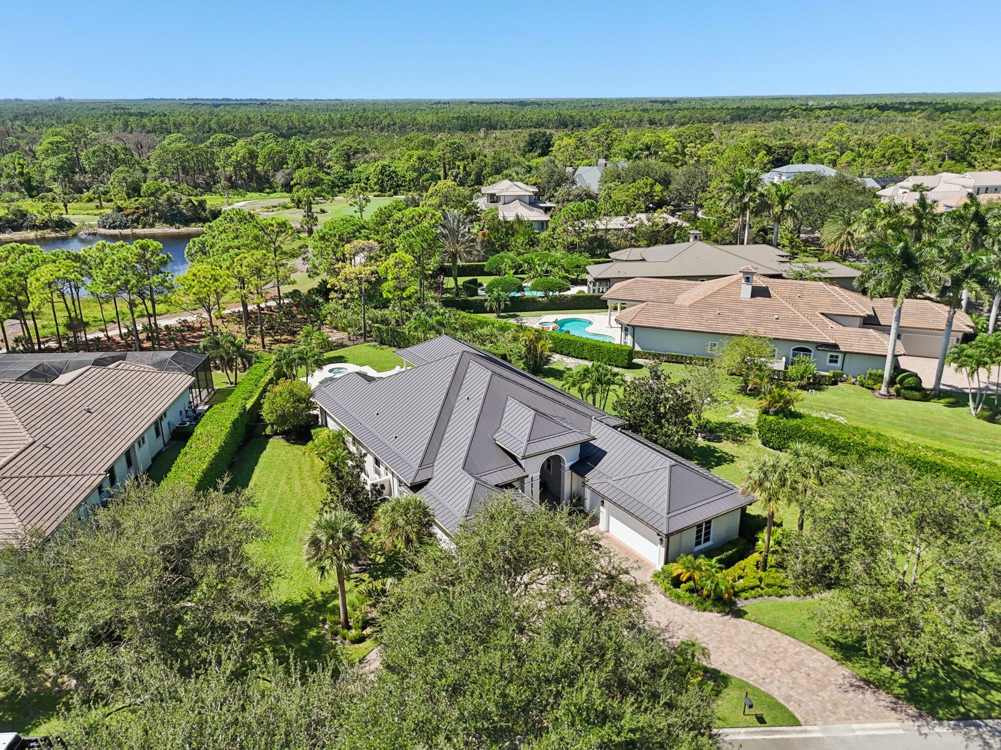 9936 Southeast Sandpine Lane Hobe Sound, FL 33455 - Photo 54 of 71 an aerial view of residential houses with outdoor space and street view