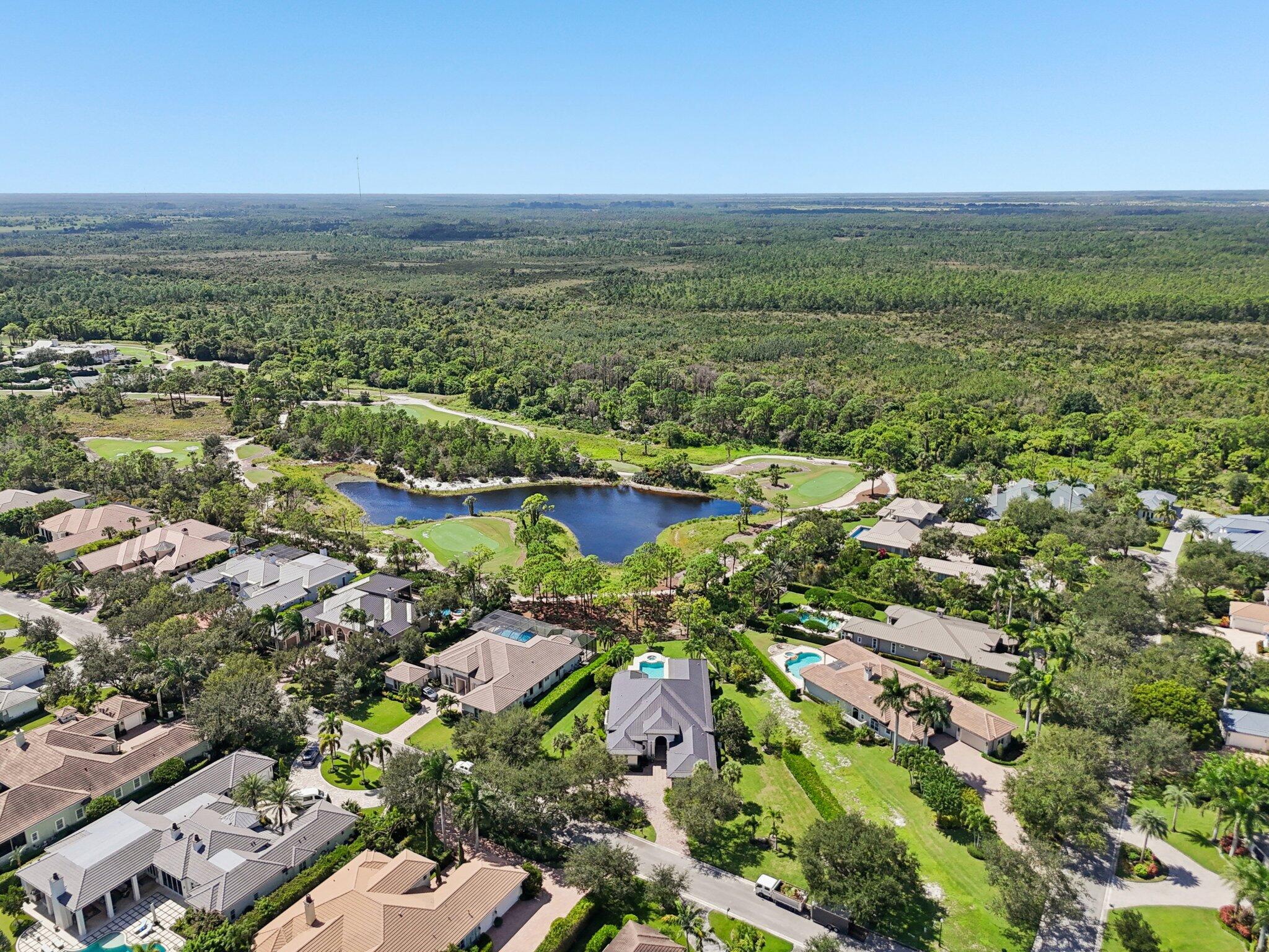 9936 Southeast Sandpine Lane Hobe Sound, FL 33455 - Photo 55 of 71 an aerial view of residential houses with outdoor space and trees