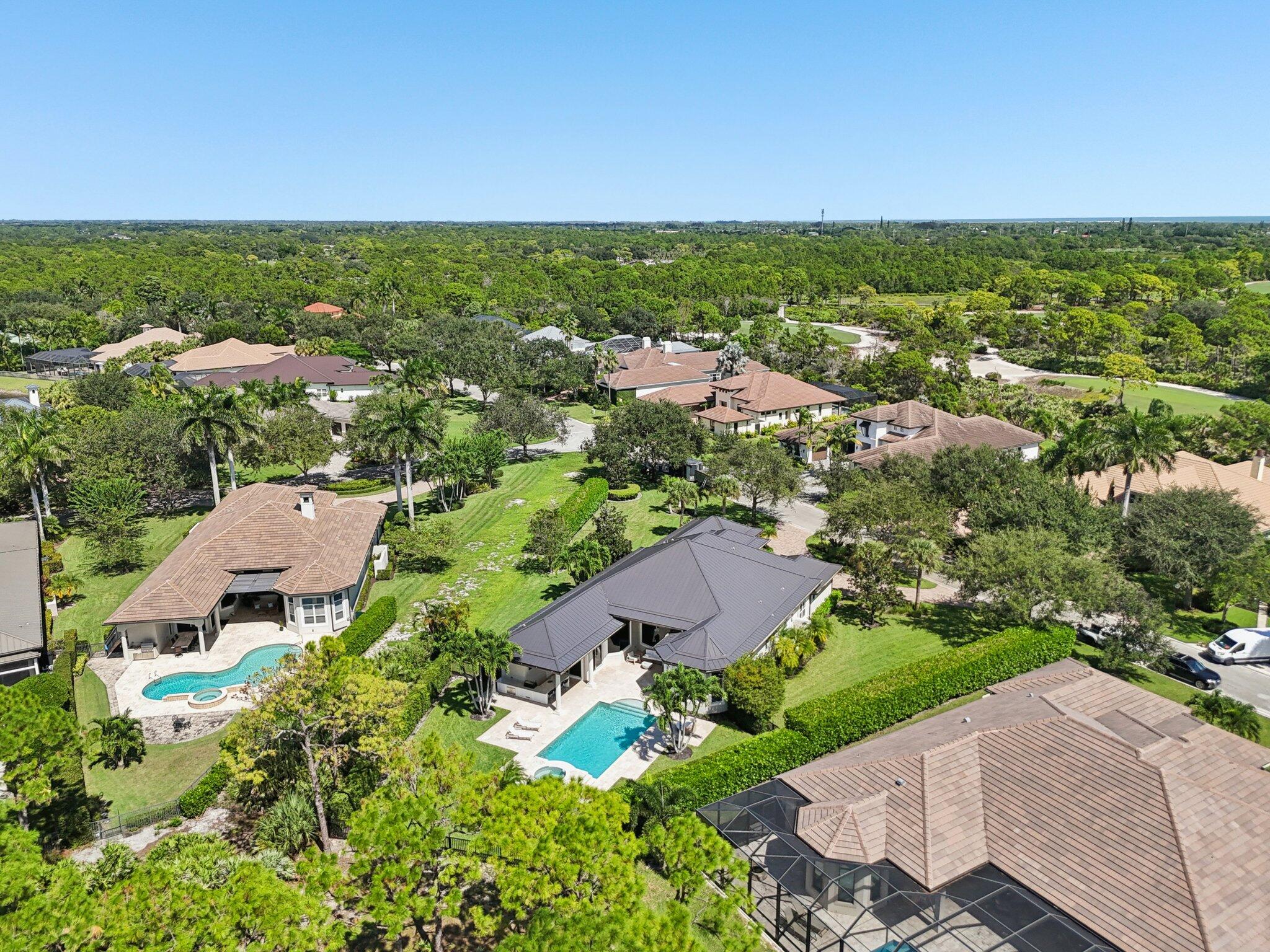 9936 Southeast Sandpine Lane Hobe Sound, FL 33455 - Photo 57 of 71 an aerial view of residential houses with outdoor space