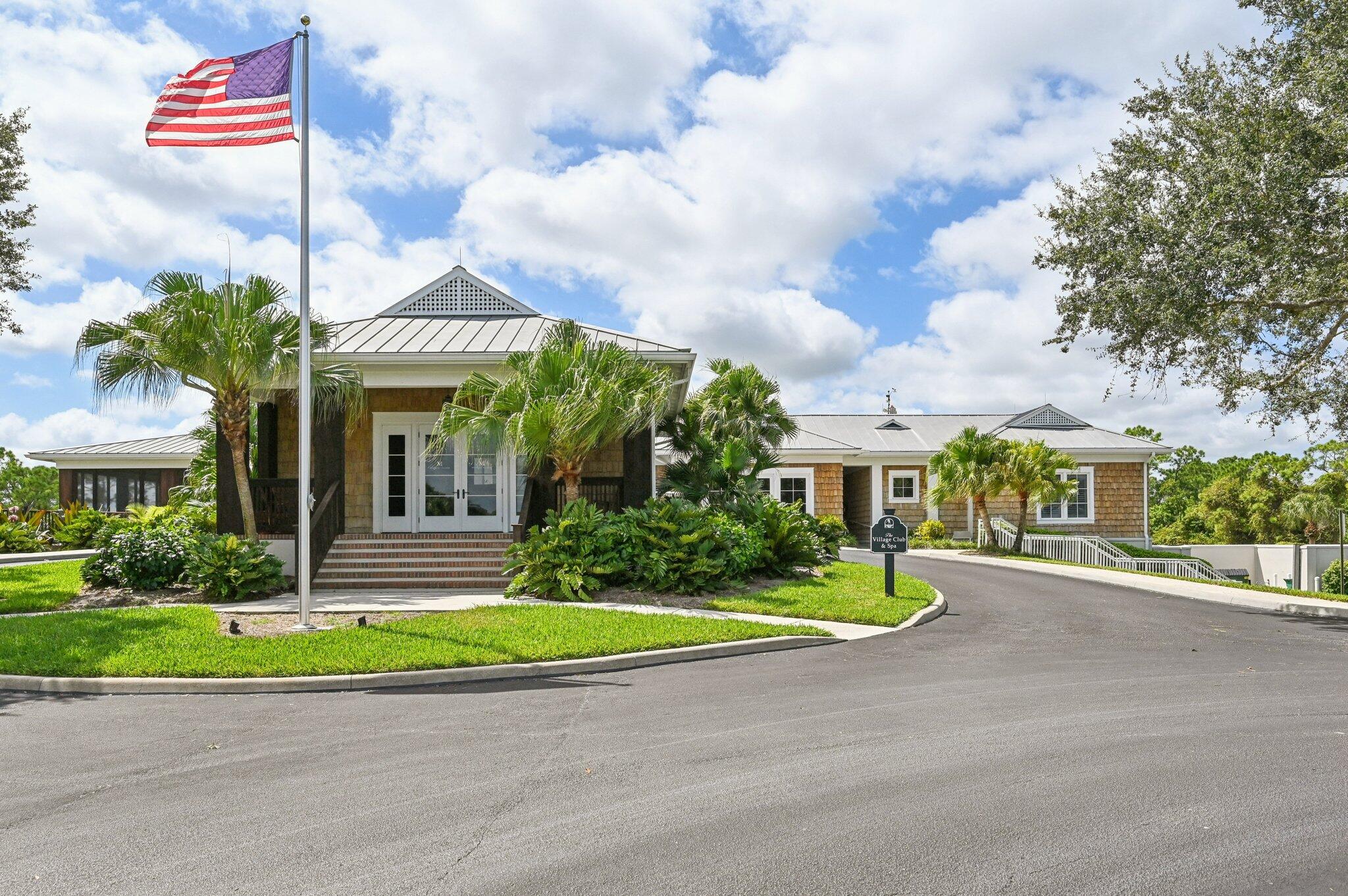 9936 Southeast Sandpine Lane Hobe Sound, FL 33455 - Photo 61 of 71 a front view of a house with a yard
