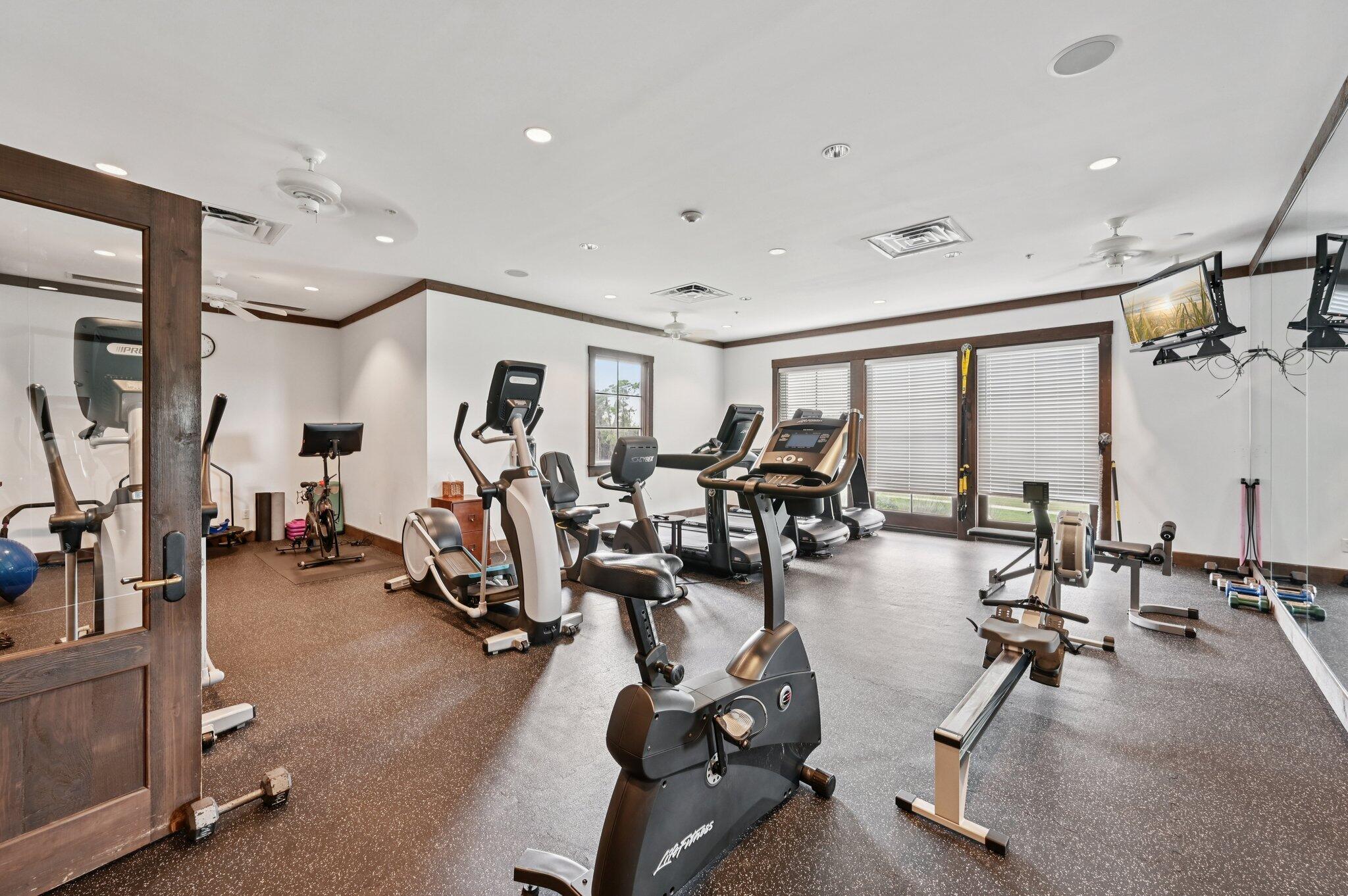 9936 Southeast Sandpine Lane Hobe Sound, FL 33455 - Photo 66 of 71 a view of a room with gym equipment