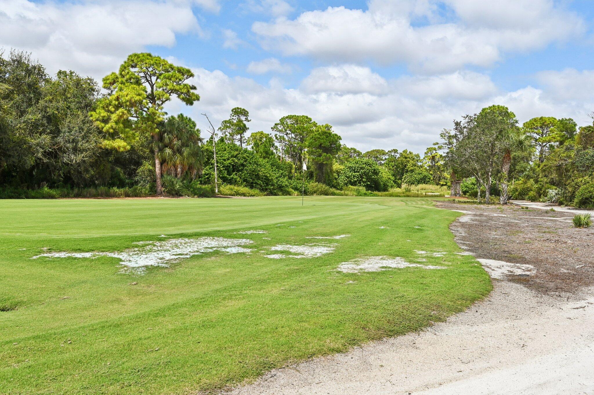 9936 Southeast Sandpine Lane Hobe Sound, FL 33455 - Photo 68 of 71 a view of a golf course with a garden