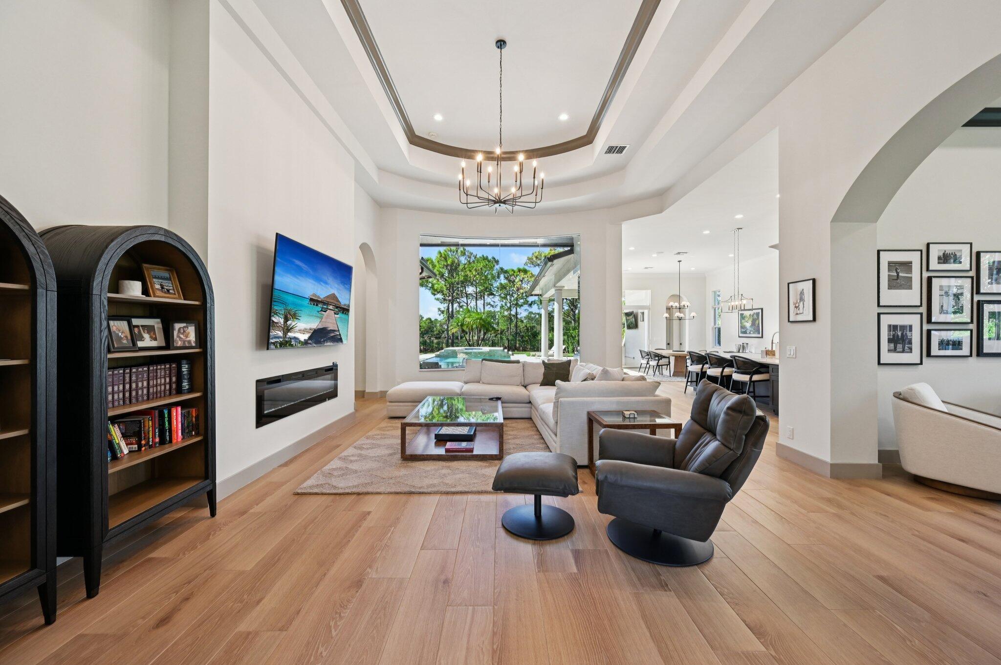 9936 Southeast Sandpine Lane Hobe Sound, FL 33455 - Photo 8 of 71 a living room with fireplace furniture and a large window