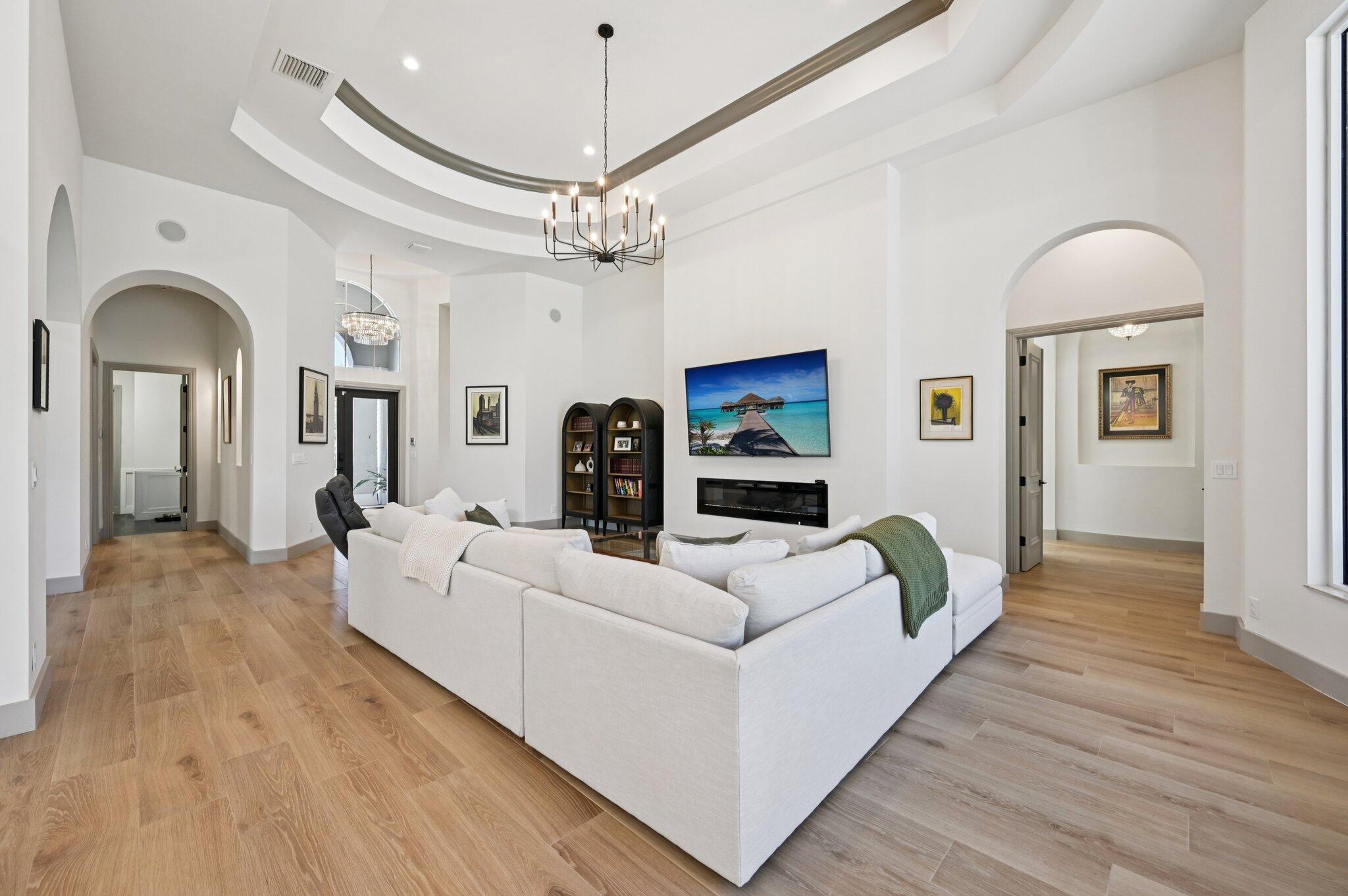 9936 Southeast Sandpine Lane Hobe Sound, FL 33455 - Photo 10 of 71 a living room with furniture chandelier and a fireplace