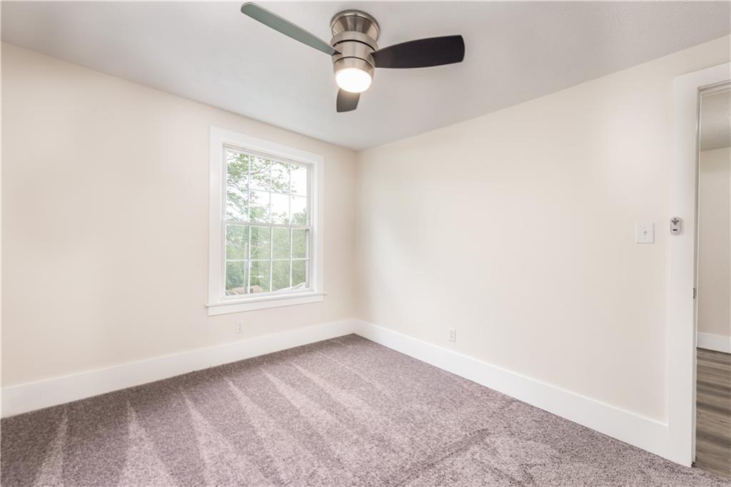 701 Main Street Irwin, PA 15642 - Photo 17 of 37 an empty room with a window and a fan