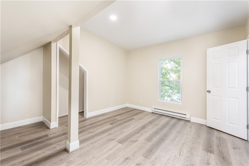 701 Main Street Irwin, PA 15642 - Photo 22 of 37 an empty room with wooden floor and window