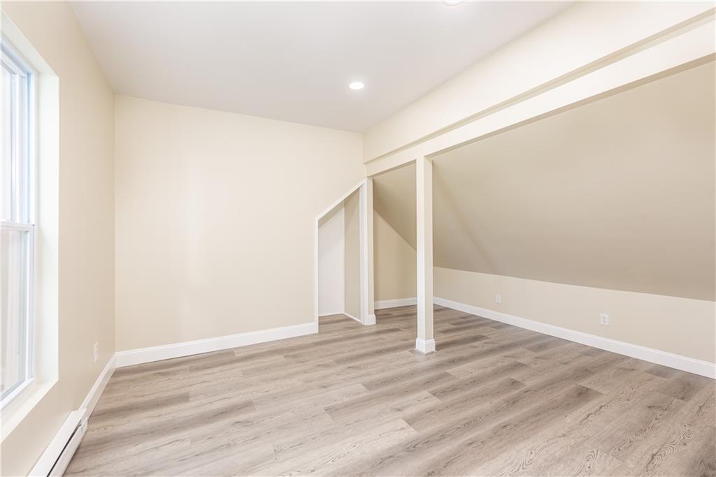 701 Main Street Irwin, PA 15642 - Photo 23 of 37 an empty room with wooden floor and entryway