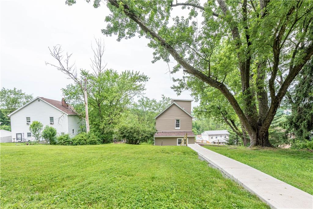 701 Main Street Irwin, PA 15642 - Photo 26 of 37 a front view of a house with garden