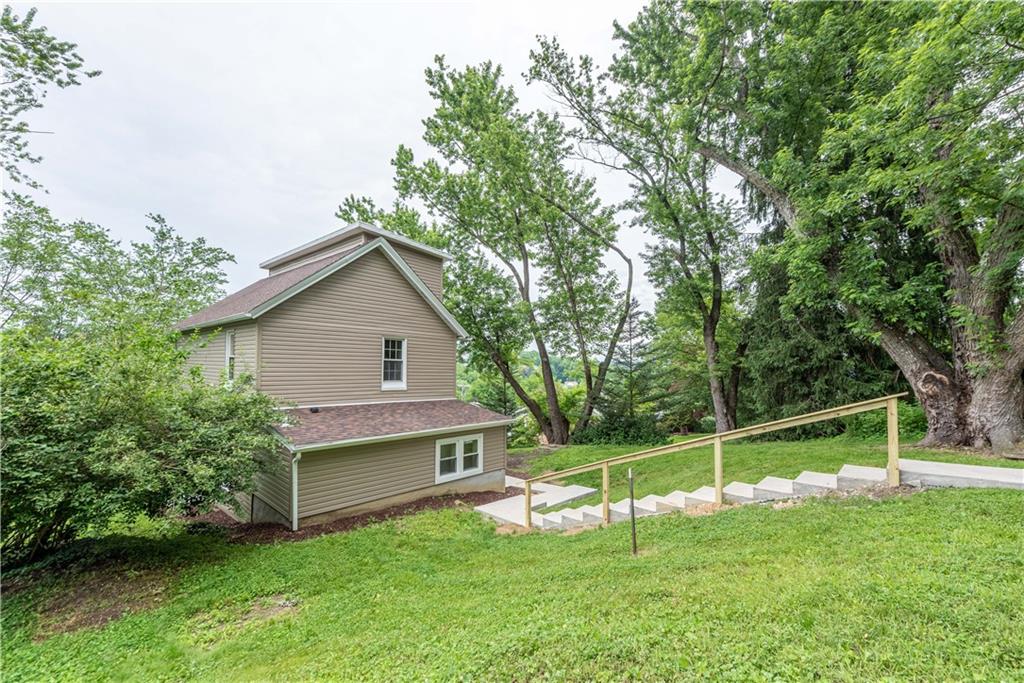 701 Main Street Irwin, PA 15642 - Photo 30 of 37 a view of a house with a yard and a large tree