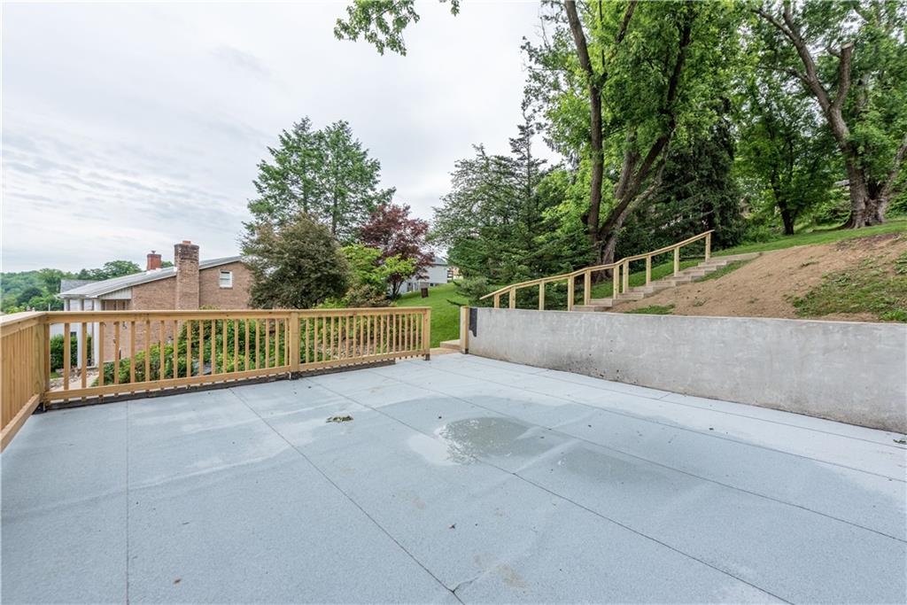 701 Main Street Irwin, PA 15642 - Photo 35 of 37 a view of a fence and trees next to a road
