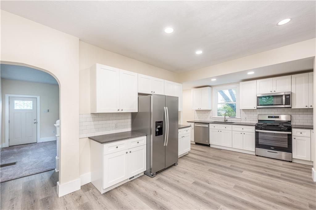 701 Main Street Irwin, PA 15642 - Photo 7 of 37 a kitchen with stainless steel appliances kitchen island granite countertop a stove refrigerator and cabinets