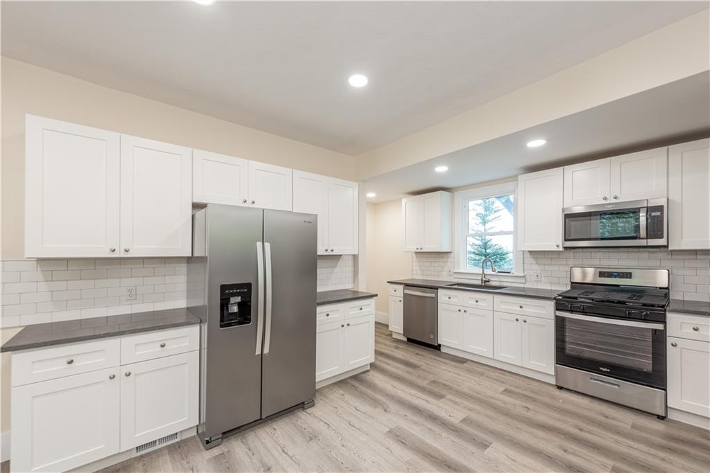 701 Main Street Irwin, PA 15642 - Photo 8 of 37 a kitchen with white cabinets and stainless steel appliances