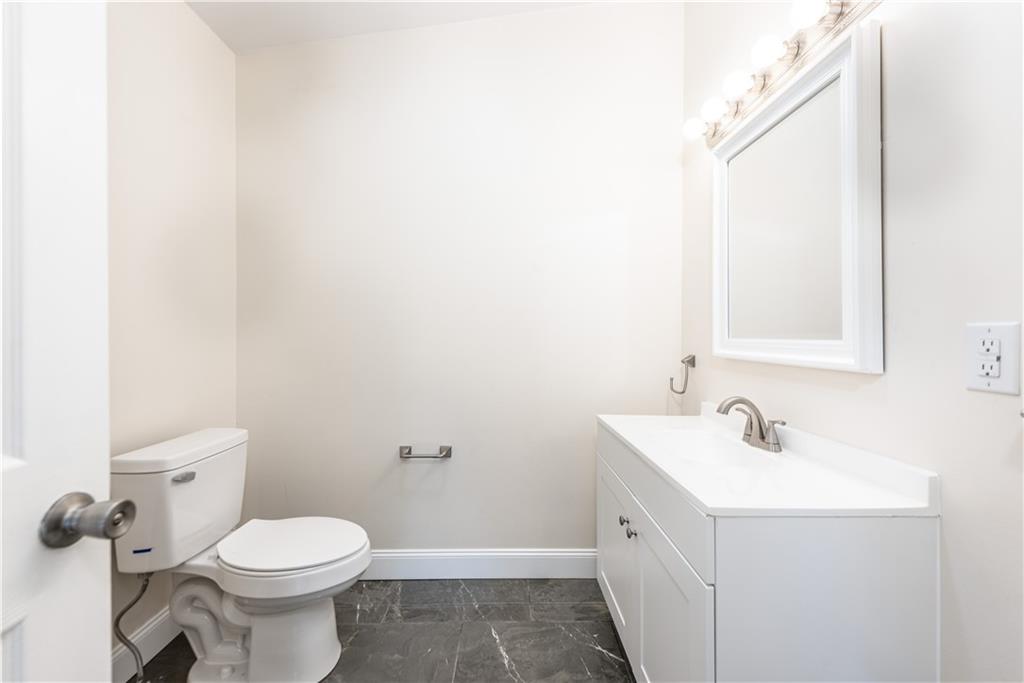 701 Main Street Irwin, PA 15642 - Photo 10 of 37 a bathroom with a toilet sink and mirror