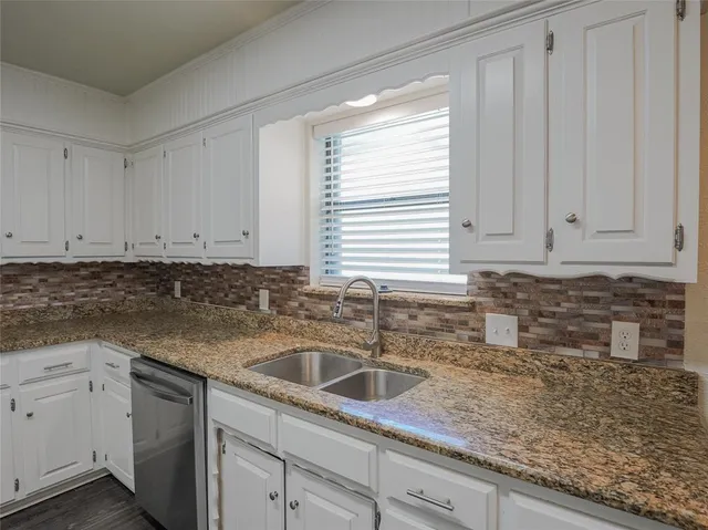 a kitchen with sink cabinets and window