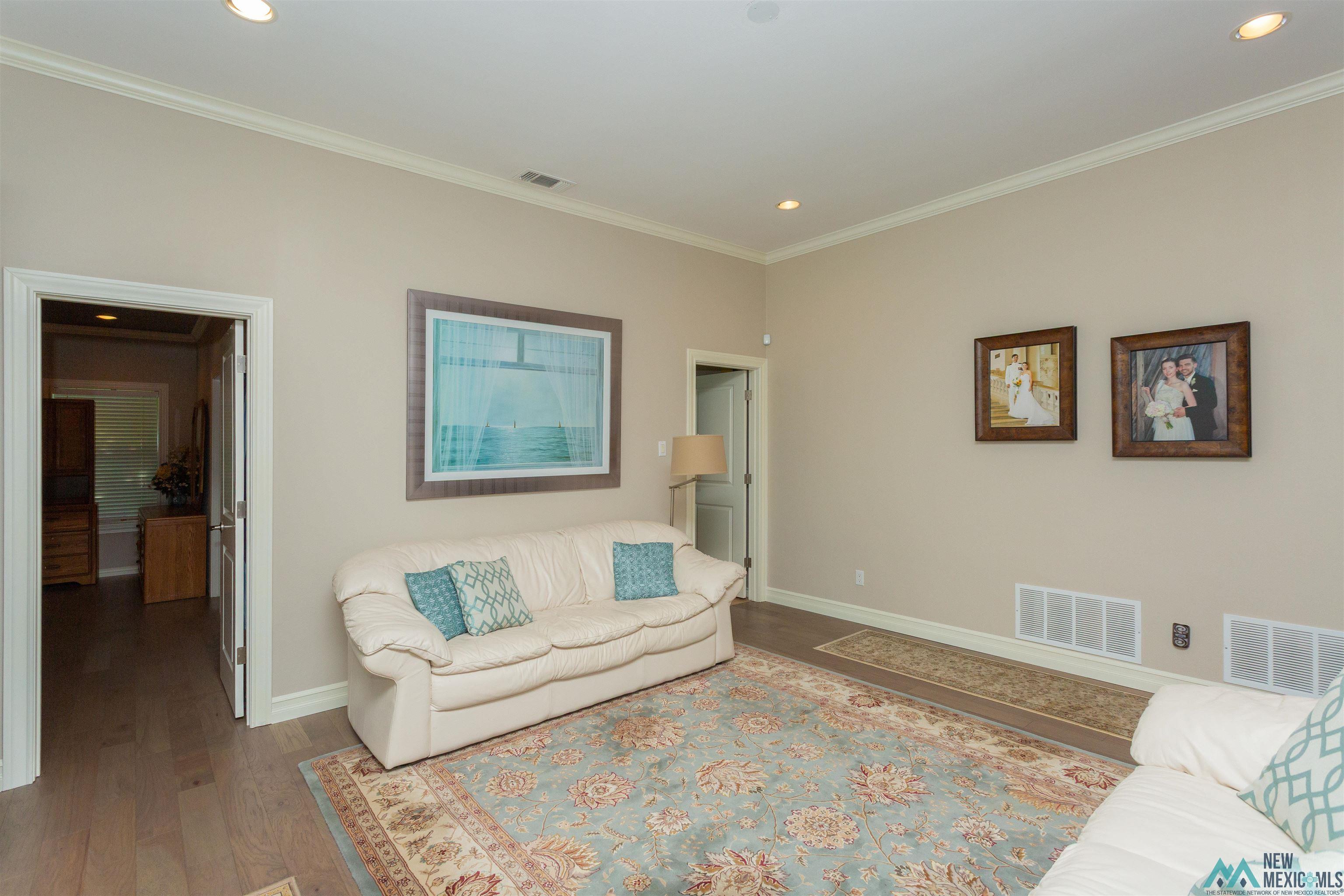 3103 Onate Road Roswell, NM 88201 - Photo 47 of 57 Living room with ornamental molding, wood finished floors, and recessed lighting