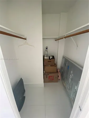 a view of walk in closet with empty racks